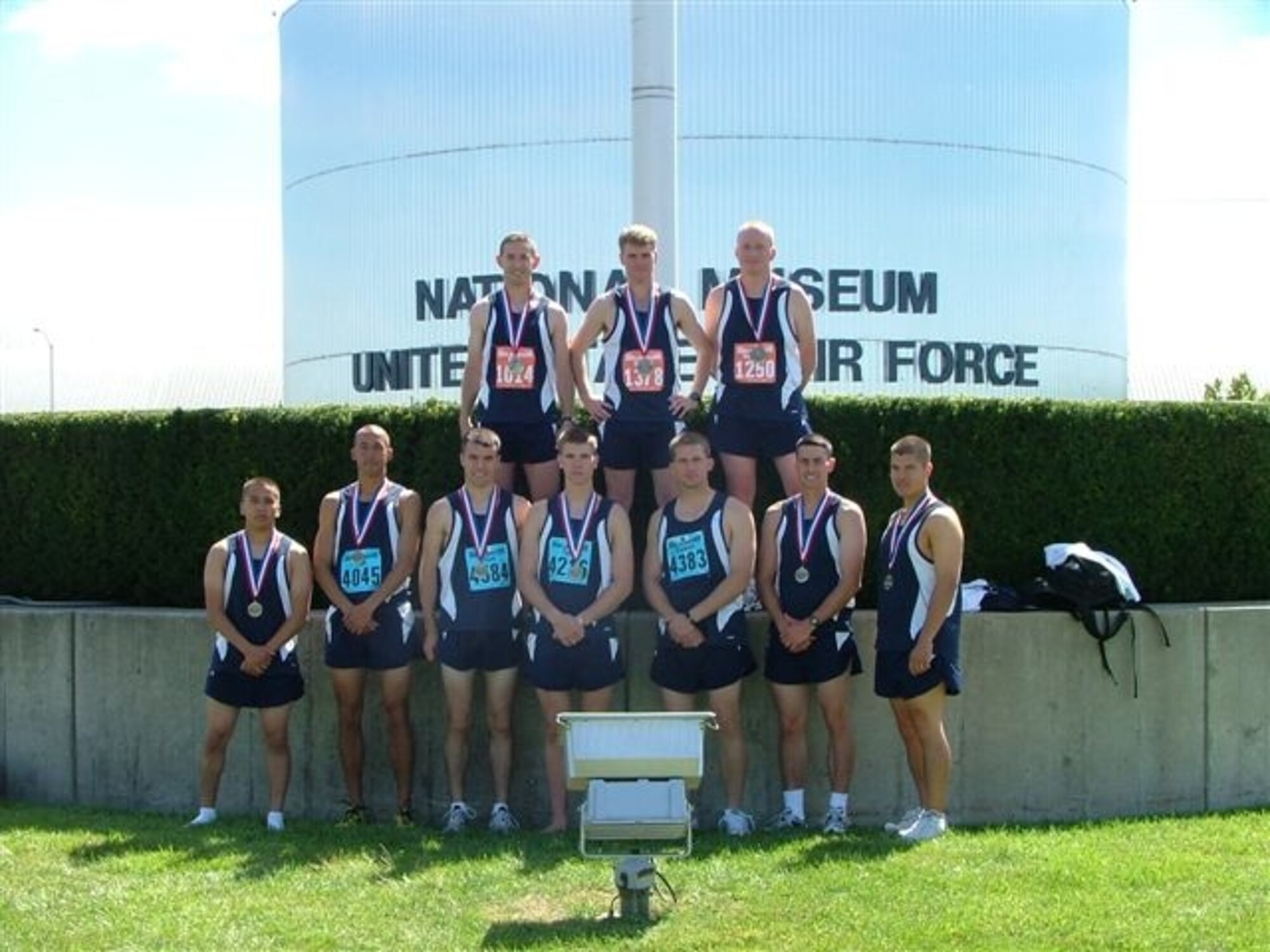 Ten members from the 311th Training Squadron pose for a group photo in front of the sign of the National Museum of the United States Air Force at Wright-Patterson Air Force Base, Ohio, after competing in the 11th Annual United States Air Force Marathon, which took place on Sept. 15. Shown here are, from left to right: (top row) Michael Park, Steven Specht, and Samuel Ronicker, (bottom row) Anthony Landrum, Ivan Alvarado, Elijah Grubb, Tyler Breske, Damian Davies, Tyler Vignolo and Fredrick Griscavage. (Air Force photo by Staff Sgt. Henry Serrano III)