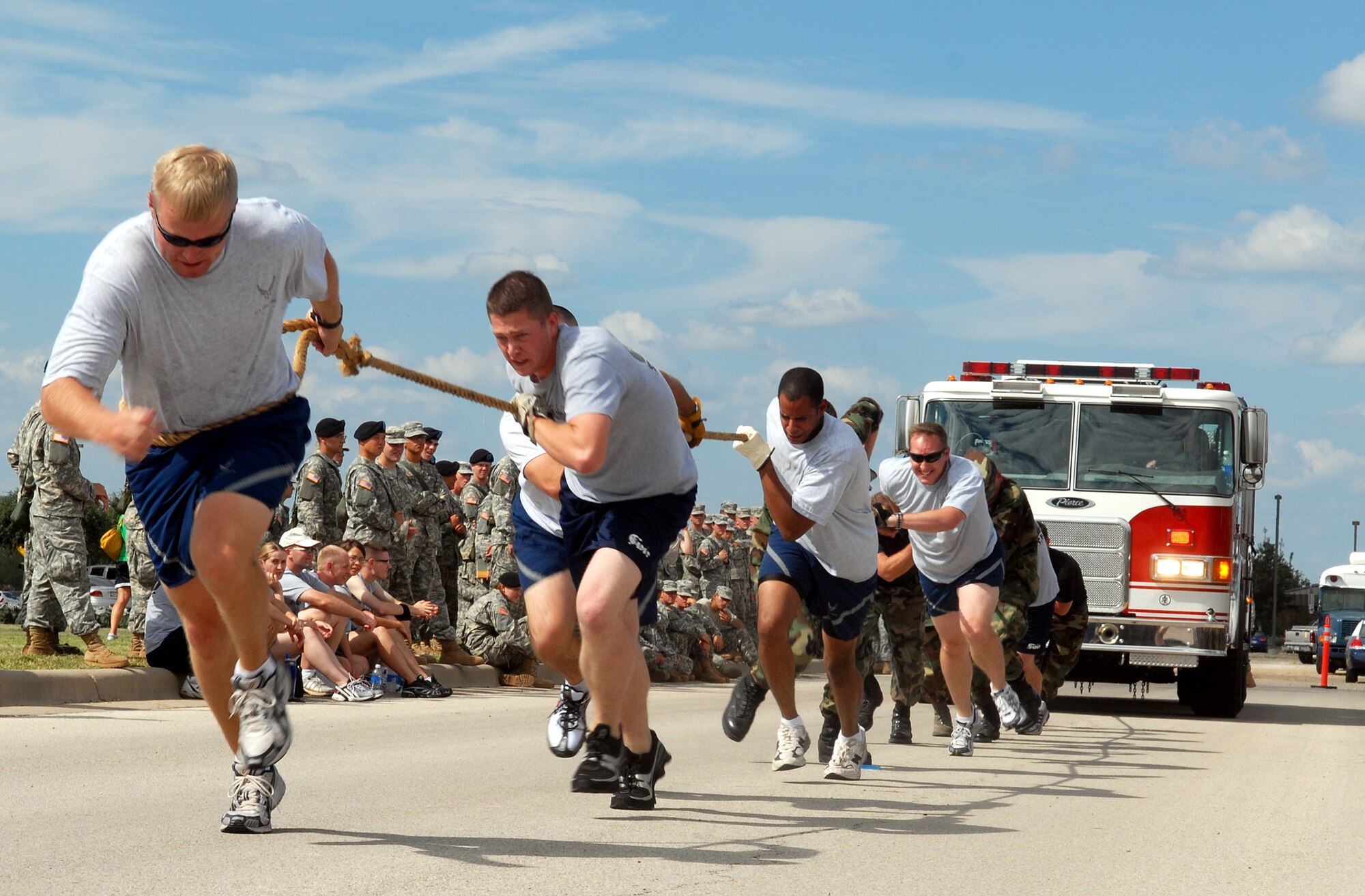 The 316th Training Squadron’s Green Worms team pull a fire truck toward the finish during the Combined Federal Campaign Fire Truck Pull Tuesday. The Green Worms, who placed third with a time of 27.5 seconds, were among 25 teams which competed to support the CFC. (U.S. Air Force photo by Airman 1st Class Kamaile Chan)