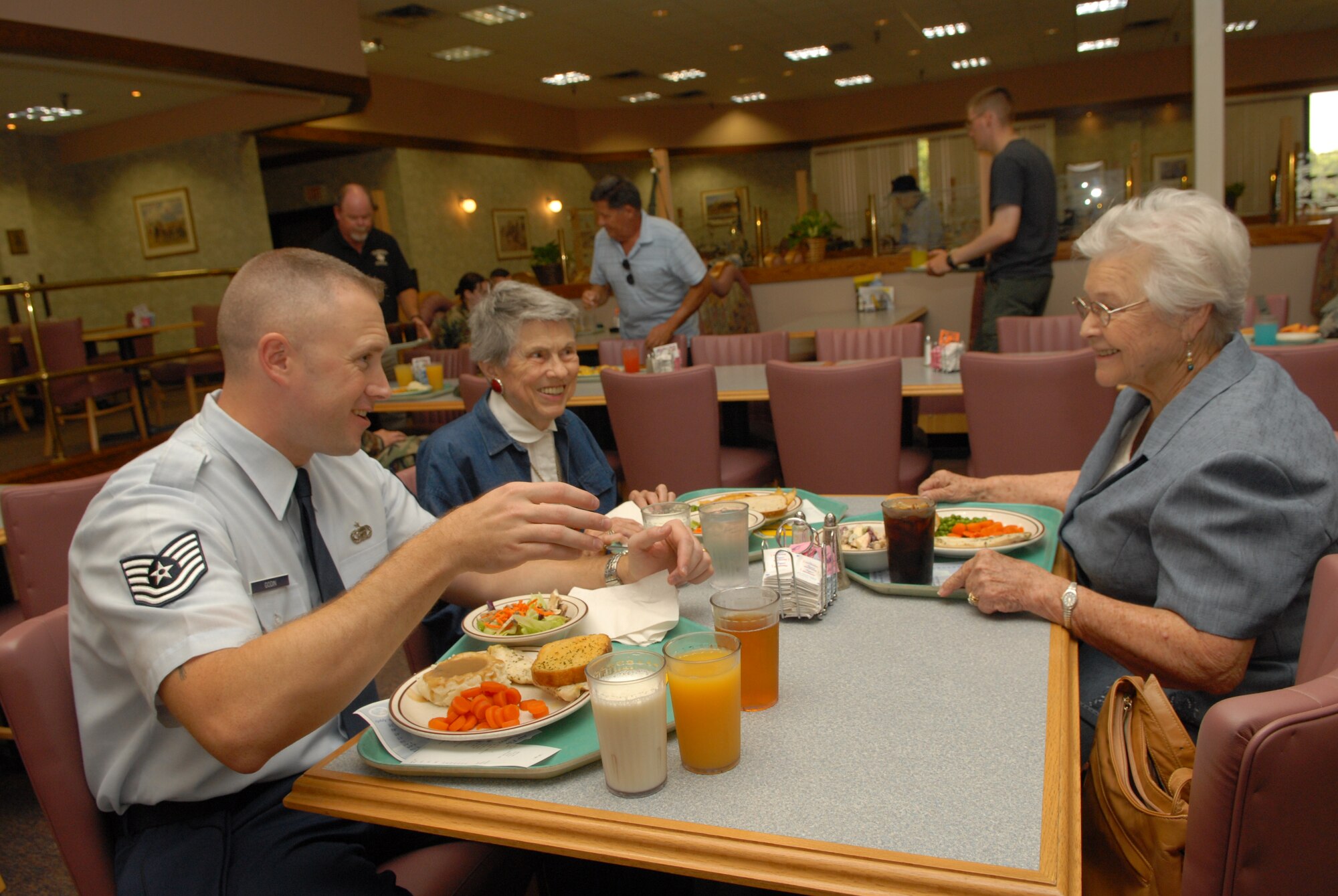 From left to right: Tech. Sgt. Lawrence Godin, of the 315th Training Squadron, talks with Hazel Dooley, widow of retired Army Lt. Col. Rosco Dooley, and Sadie Cawyer, widow of retired Master Sgt. J.R. Cawyer, at the Air Force 60th Anniversary Retiree Luncheon Sept. 18 at the Western Winds Dining Facility. (U.S. Air Force photo by Tech. Sgt. Randy Mallard)