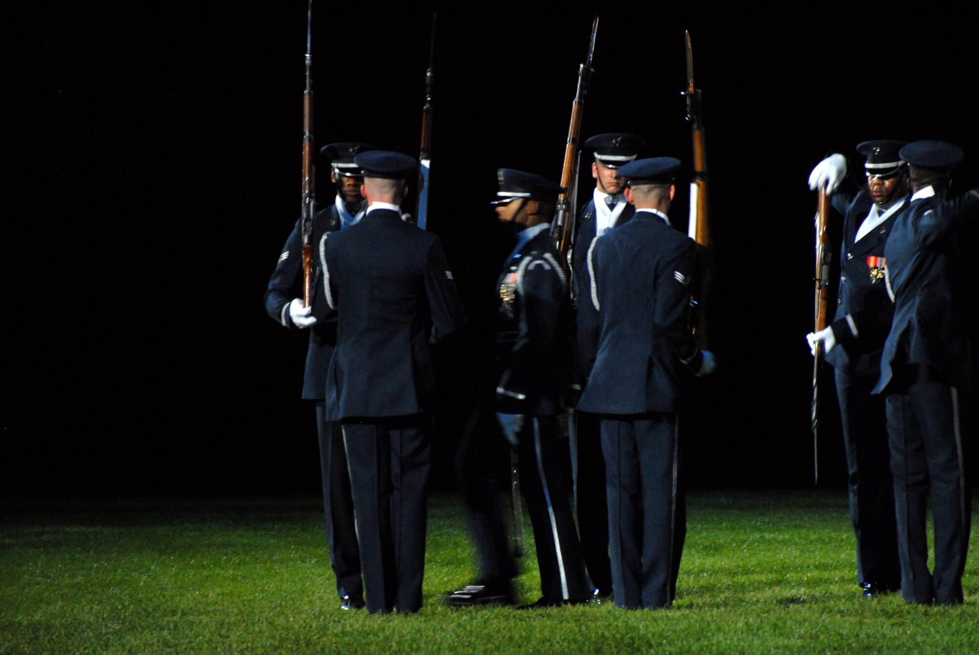 BOLLING AFB, D.C. -- Capt. Joshua Hawkins, Air Force Honor Guard Drill Team commander, walks through a "gauntlet" of spinning rifles during the team's performance at the 60th Anniversary Air Force Tattoo dress rehearsal Sept. 22.
The military tattoo, which is held annually at Bolling, highlights troop excellence and readiness.  The tattoo dates back to the mid-17th century British Army deployment to the Netherlands in which drummers were sent from the garrison to the towns at 9:30 each night to let soldiers know it was time to return to the fort.
(U.S. Air Force photo by Staff Sgt. Madelyn Waychoff)