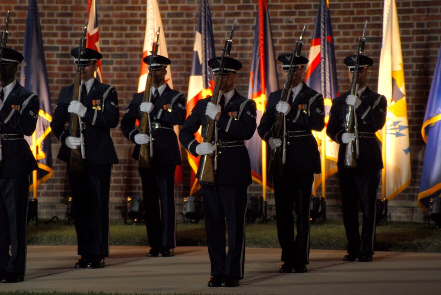BOLLING AFB, D.C. -- Airmen from the Air Force Honor Guard stand ready in formation before performing marching orders and rifle manuals at the 60th Anniversary Air Force Tattoo dress rehearsal Sept. 22.
The military tattoo, which is held annually at Bolling, highlights troop excellence and readiness.  The tattoo dates back to the mid-17th century British Army deployment to the Netherlands in which drummers were sent from the garrison to the towns at 9:30 each night to let soldiers know it was time to return to the fort.
(U.S. Air Force photo by Staff Sgt. Madelyn Waychoff)