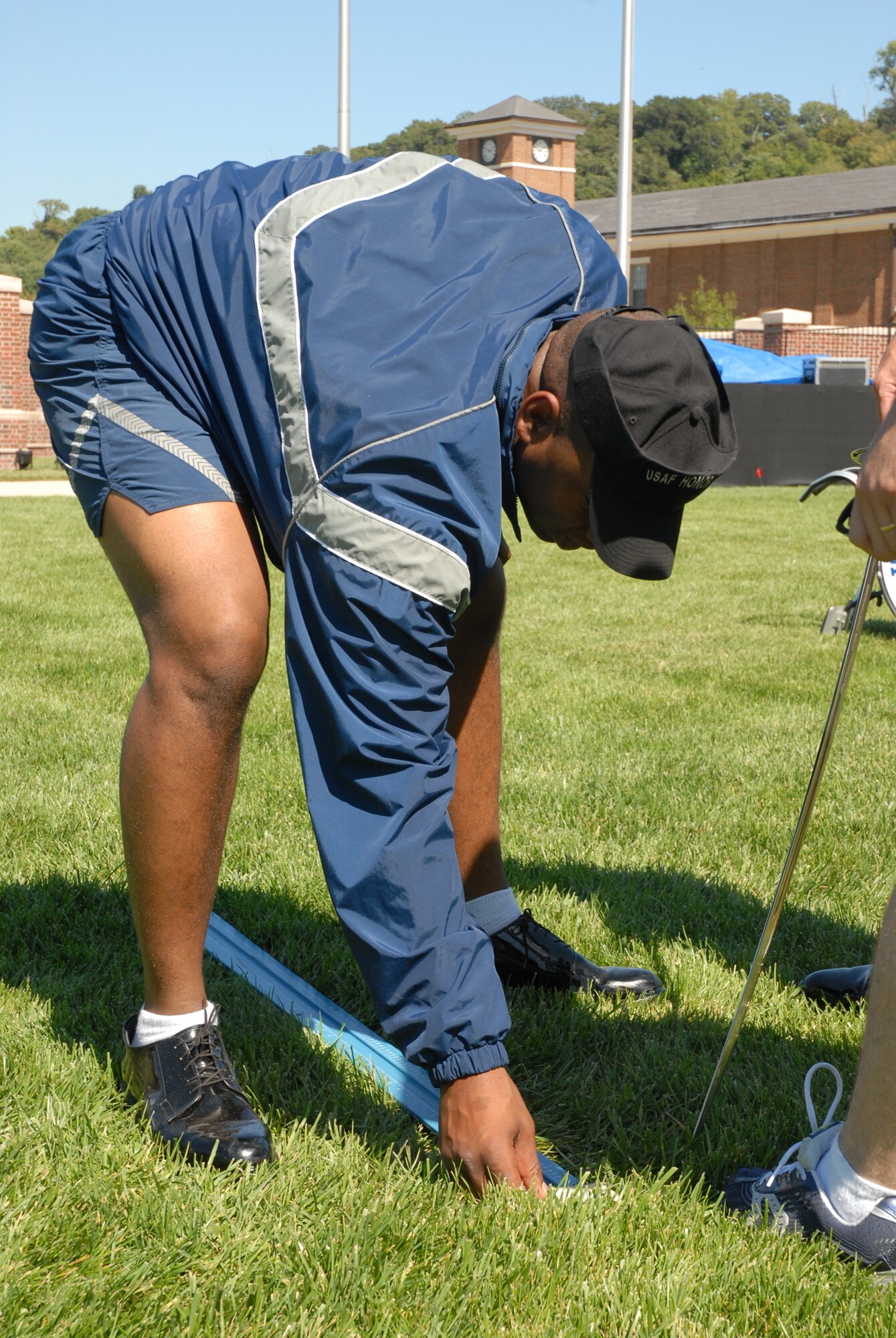 BOLLING AFB, D.C. -- Senior Airman Lee Langston, Air Force Honor Guard ceremonial guardsman, measures out a "mark" to indicate a precise stopping point the Airmen use during the tattoo.  More than a month of practices went into the preparation for the 60th Anniversary Air Force Tattoo Sept. 23, including two weeks of intense rehearsal on top of the daily duties of the honor guard and Air Force Band.
The military tattoo, which is held annually at Bolling, highlights troop excellence and readiness.  The tattoo dates back to the mid-17th century British Army deployment to the Netherlands in which drummers were sent from the garrison to the towns at 9:30 each night to let soldiers know it was time to return to the fort.
(U.S. Air Force photo by Staff Sgt. Madelyn Waychoff)