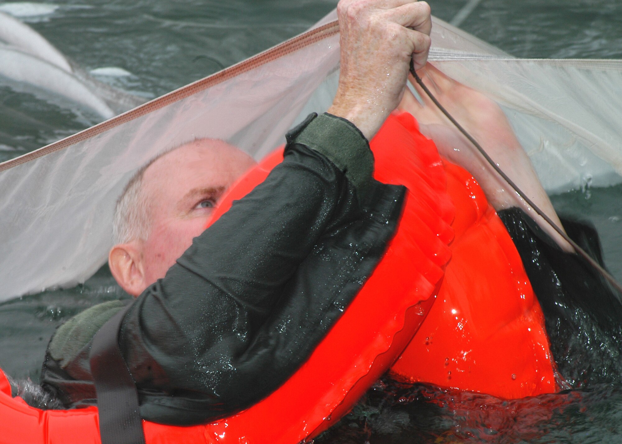 GRISSOM AIR RESERVE BASE, Ind., -- Lt. Col. Thom Pemberton, 72nd Air Refueling Squadron diretor of operations, prepares to make his way under a parachute canopy as part of water survival training. Approximately 25 aircrew members went through the training at a remote lake in Cass County. Colonel Pemberton is a Howard County resident.  (U.S. Air Force photo/Tech. Sgt. Doug Hays)