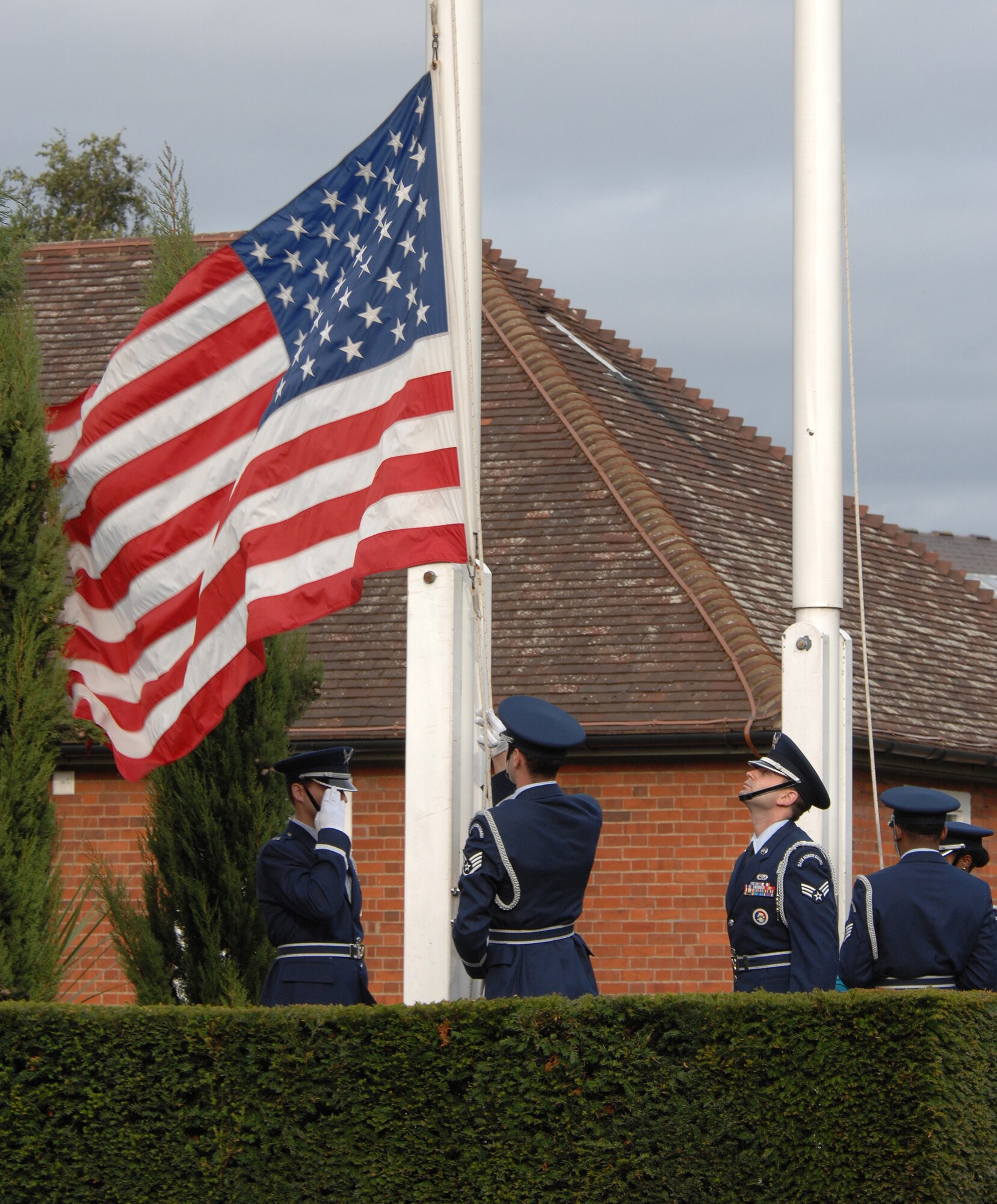 Airmen of the RAF Mildenhall Honor Guard lower the American flag during Retreat to honor those military members either captured or missing as part of the annual Prisoner of War/Missing in Action week of remembrance, Sept. 21, 2007.
(U.S. Air Force photo by Tech. Sgt. Tracy L. DeMarco)

