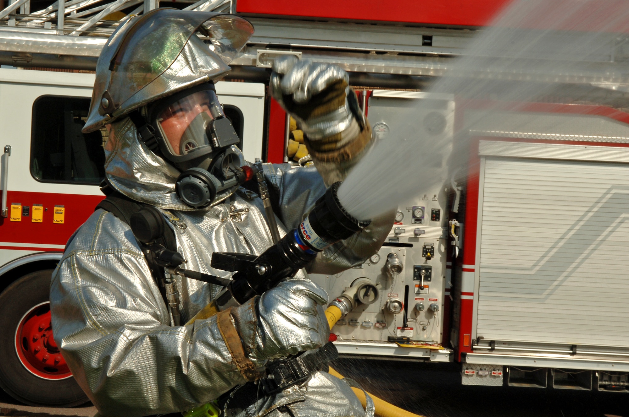 Michael Luba, 435th Civil Engineer Squadron firefighter, performs an operation check on a high-pressure hose during a major accident response exercise on Ramstein Air Base, Germany, Sept. 22. The exercise was based on the collision of a truck carrying ammonia and another carrying radiological waste. This exercise tested the procedures of medical, fire, and law enforcement squadrons stationed at Ramstein as well as organizations from the German community. (U.S. Air Force photo/Airman 1st Class Marc I. Lane)
