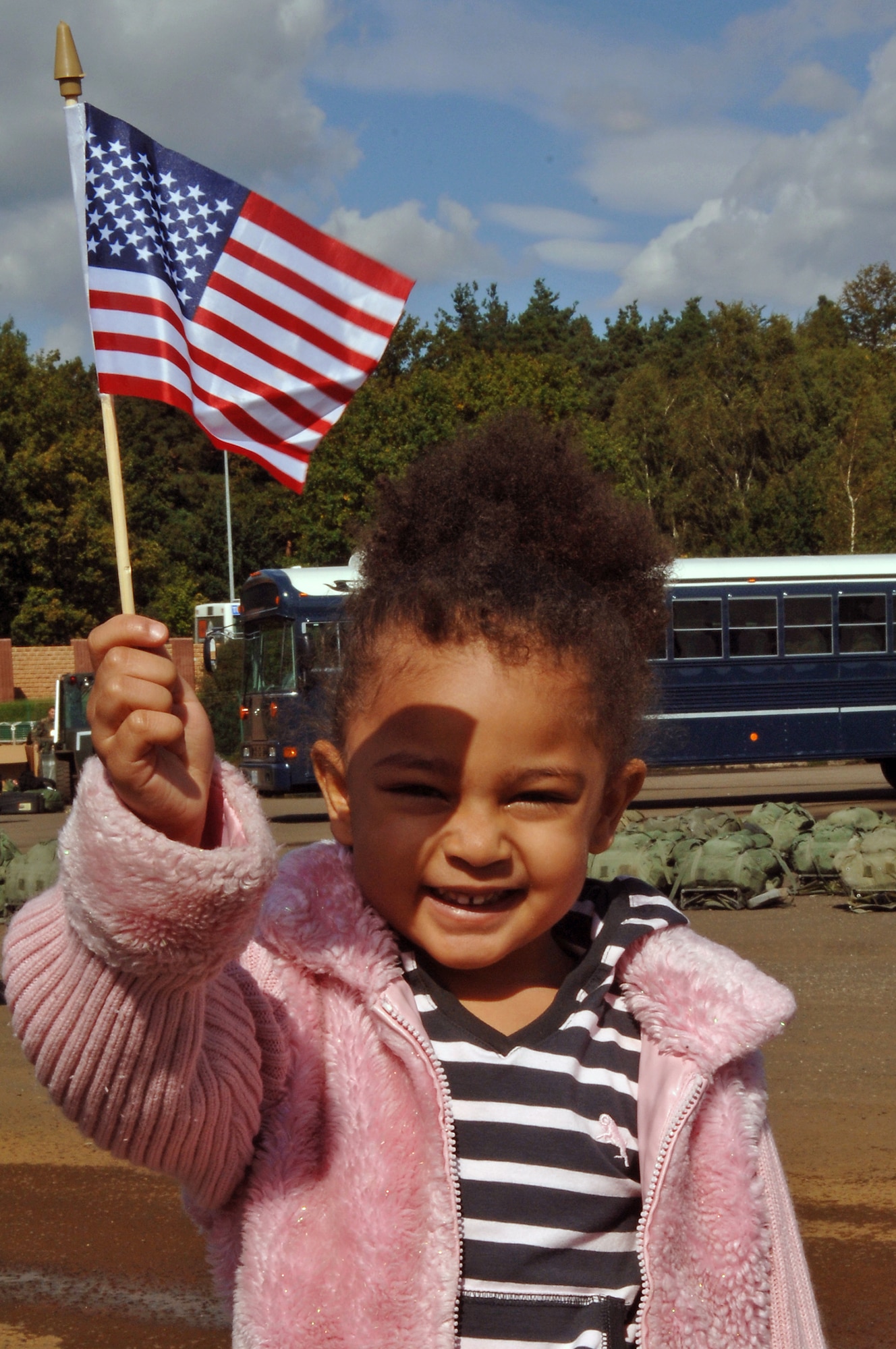 Omeya Dozier, daughter of Senior Airman Kevin Dozier, waves an American flag while waiting at the Joint Mobility Processing Center on Ramstein Air Base, Germany, Sept. 19. (U.S. Air Force photo/Airman 1st Class Marc I. Lane)