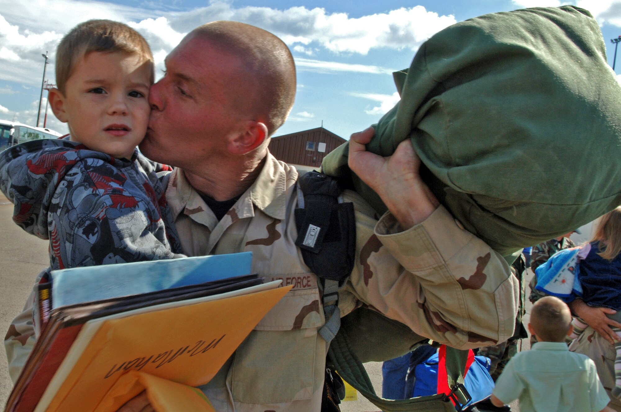Senior Airmen (SrA) Johnny McMahan, 435th Vehicle Readiness Squadron, kisses his son Zeffrey on Ramstein Air Base, Germany, Sept. 19. SrA McMahan returned to his family safely from a deployment to Balad Air Base, Iraq. (U.S. Air Force photo/Airman 1st Class Marc I. Lane)