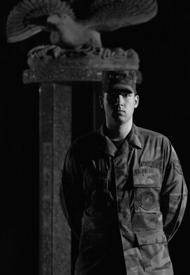 In the early evening, Airman 1st Class Eric Kelly, from the 352nd Maintenance Squadron, stands guard at the Prisoner of War/ Missing in Action memorial on RAF Mildenhall, during a 24-hour vigil to remember those captured or lost, Sept. 20, 2007. Volunteers are needed for this year's vigil held Sept. 17 -18. (U.S. Air Force file photo/Tech. Sgt. Tracy L. DeMarco)
