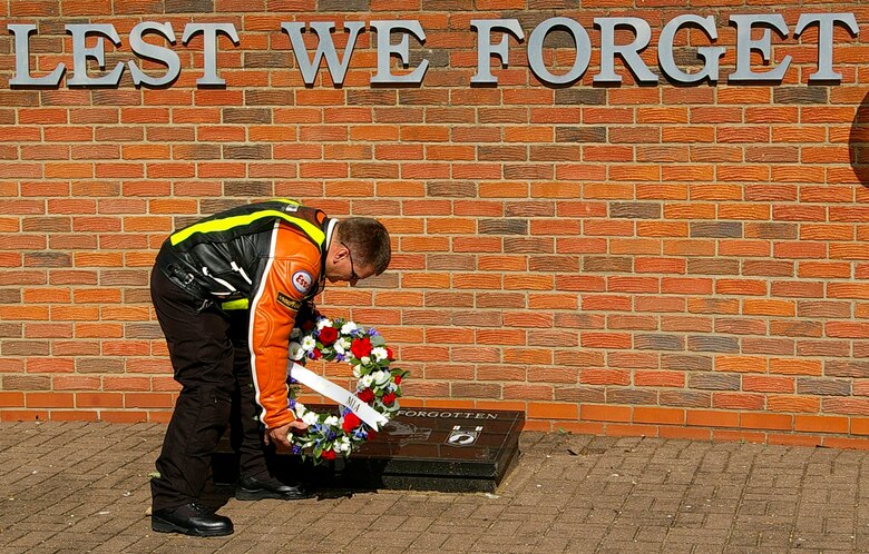 Master Sgt. Robert Emond, 100th Maintenance Squadron, lays a wreath at Memorial Park, RAF Lakenheath, after 20 motorcyclists rode in a convoy from RAF Mildenhall to RAF Lakenheath Tuesday as part of POW/MIA Week events. The wreath was provided by the Air Force Sergeants Association. (U.S. Air Force photo by Karen Abeyasekere)