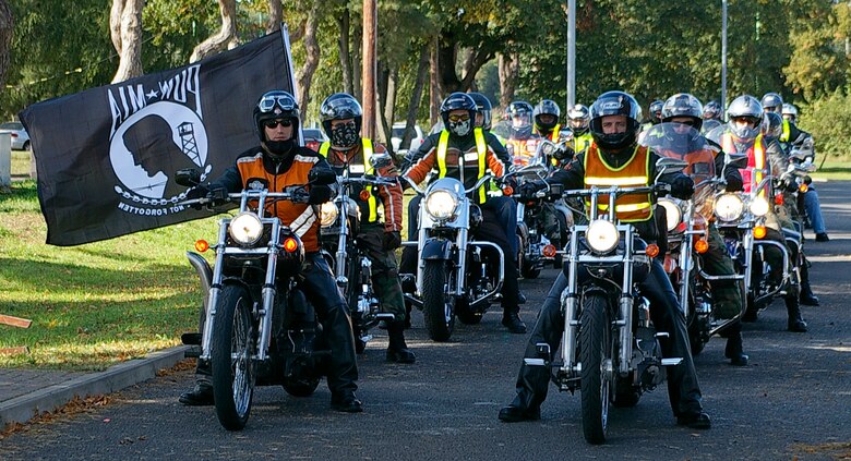 Twenty riders from RAFs Mildenhall and Lakenheath take part in a motorcycle convoy from RAF Mildenhall to RAF Lakenheath Tuesday as part of Prisoner of War/Missing in Action/Fallen Comrade Week activities. At RAF Lakenheath, one of the motorcycle riders laid a wreath at the "Lest We Forget" wall at Memorial Park. (U.S. Air Force photo by Karen Abeyasekere)