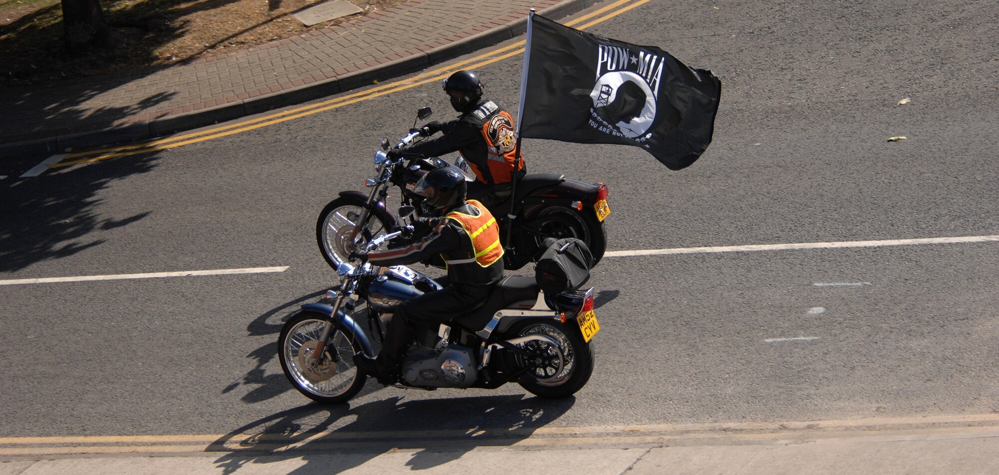 Staff Sgt. Jonathan Richichi, from RAF Lakenheath's  48th Communications Squadron, carrying the Prisoner of War/Missing in Action flag, along with Master Sgt. Robert Emond, from RAF Mildenhall's 100th Maintenance Squadron, takes part in the Rolling Thunder 2007 Motorcycle Ride during POW/MIA/Fallen Comrades week, Sept. 18, 2007. Sergeant Emond volunteered to lead this year's ride and this is Sergeant Richichi's second year participating in the event.
(U.S. Air Force Photo by Tech. Sgt. Tracy L. DeMarco)
