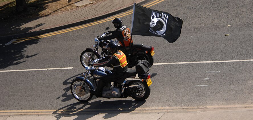Staff Sgt. Jonathan Richichi, 48th Communications Squadron, carrying the Prisoner of War/Missing in Action flag, and Master Sgt. Robert Emond, 100th Maintenance Squadron, participate in the Rolling Thunder 2007 Motorcycle Ride during POW/MIA/Fallen Comrades week, Sept. 18, 2007. This year's ride takes place Sept. 16. (U.S. Air Force file photo by Master Sgt. Tracy DeMarco)