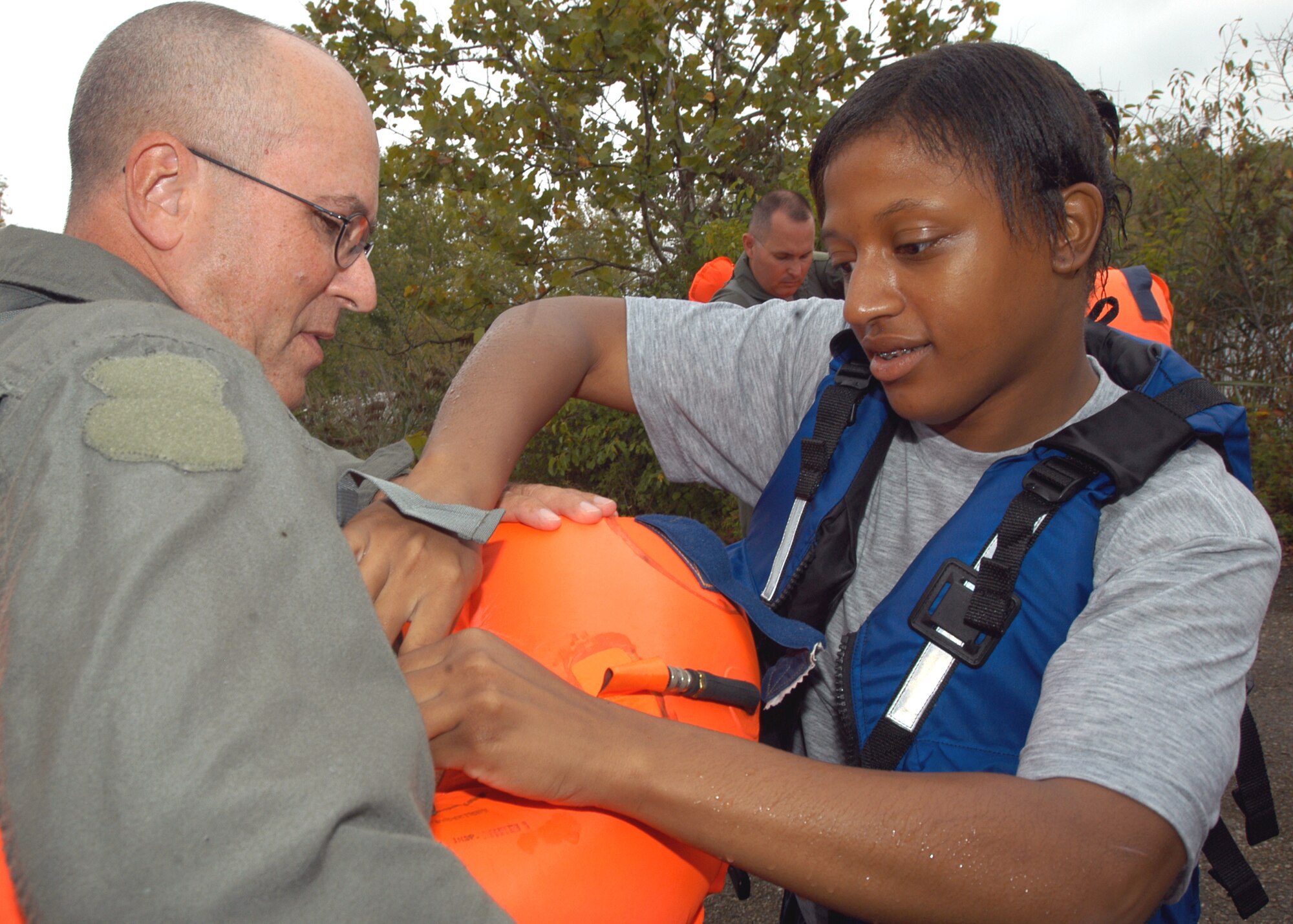GRISSOM AIR RESERVE BASE, Ind., -- Tech. Sgt. Joe Swisher, an inflight refueling specialist from Wabash, Ind., is assisted with his life preserver by Senior Airman Kellin McCamey, a survival equipment apprentice with the 434th Maintenance Squadron, during water survival training held at a lake in Cass County during the September unit training assembly. (U.S. Air Force photo/Tech. Sgt. Doug Hays)