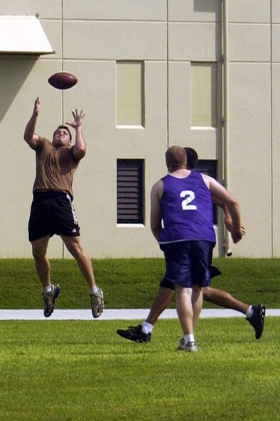 A Special Operations Command, Pacific player leaps to catch a pass thrown his way. The SOCPAC team beat the 506th Air National Guard team on Sept. 22.        