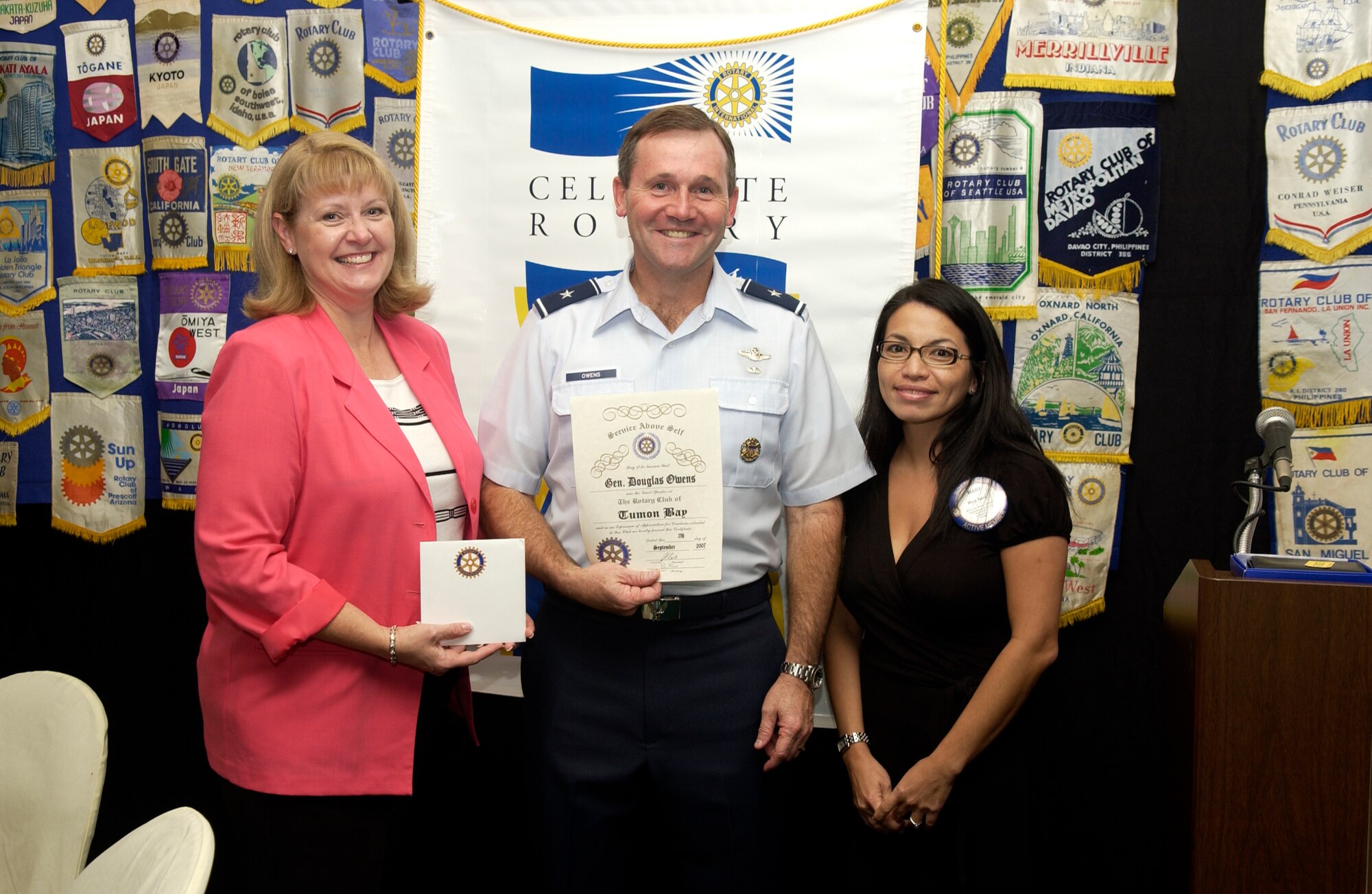 ANDERSEN AFB, GUAM---Mary P. Torre, President, Guam Hotel and Restaurant Association, presents Brigadier General Douglas H. Owens, Commander, 36th Wing, and his wife, Teresa, with a Certificate of Appreciation during a meeting held by the Rotary Club of Tumon Bay on September 25th, 2007.  General Owens attended the meeting as a guest speaker. (U.S. Air Force photo by Senior Airman Miranda Moorer)(RELEASED)                                     