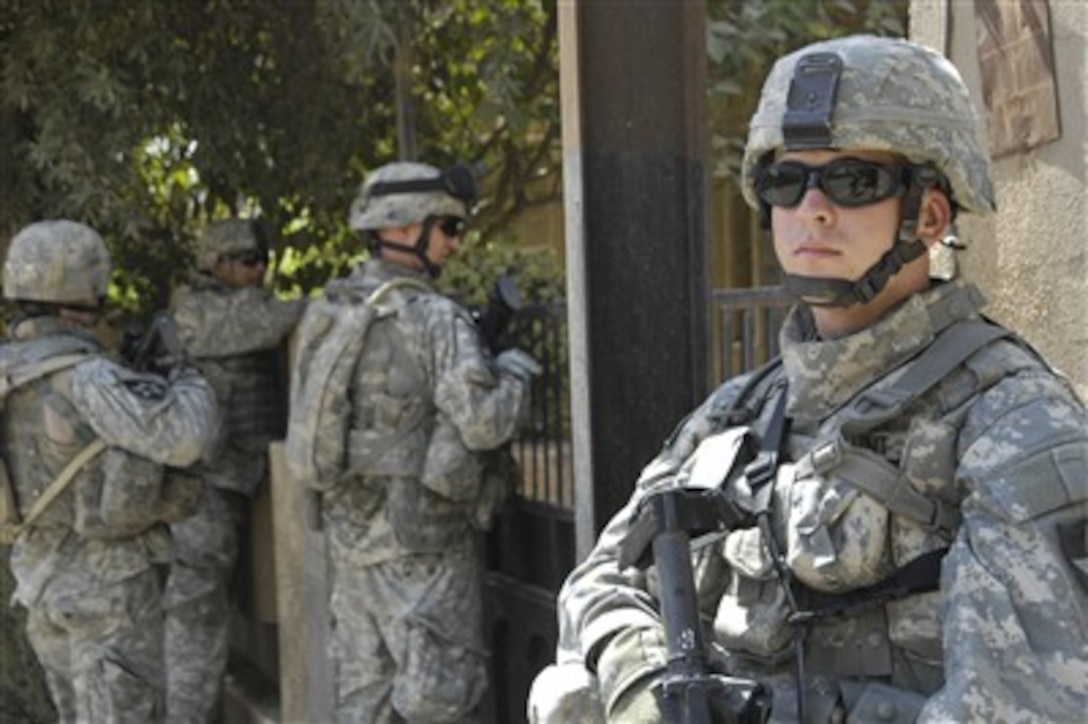U.S. Army Pvt. Joseph M. Dement (right) provides security in the city of Dora in Southern Baghdad, Iraq, on Sept. 20, 2007.  Dement is assigned to 4th Platoon, Delta Company, 2nd Battalion, 12th Infantry Regiment, 2nd Brigade Combat Team, 2nd Infantry Division.  