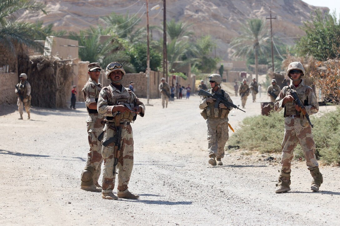 EXPEDITIONARY PATROL BASE - DULAB, Iraq, (Sept. 26, 2007) – Iraqi Army soldiers and Marines with Company A, 1st Battalion, 7th Marine Regiment, Regimental Combat Team 2, walk through the town on a foot patrol during the Operation Bell Hurriyah. Bell Hurriyah, which means Enjoy Freedom, is battalion-wide operation directed at stopping the increase of insurgent activity during the Muslim holy month of Ramadan. Official Marine Corps Photo By Cpl. Ryan C. Heiser.