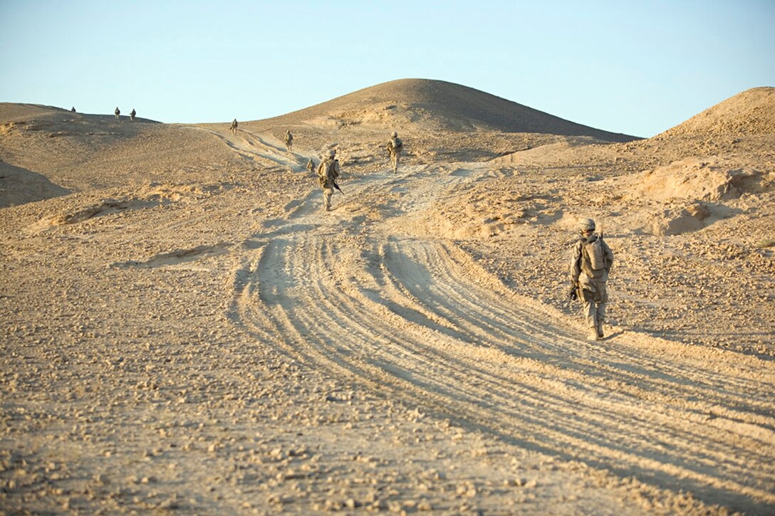 EXPEDITIONARY PATROL BASE - DULAB, Iraq, (Sept. 26, 2007) – Marines with 1st Platoon, Company A, 1st Battalion, 7th Marine Regiment, Regimental Combat Team 2, venture into the desert around the city in a staggered column on their way to an aver watch position. The Marines of Company A, known as the “Animals,” spend most of their time on foot patrols in or around the city, or in over watch positions for Iraqi Security Forces.(Official USMC photograph by Cpl. Shane S. Keller)