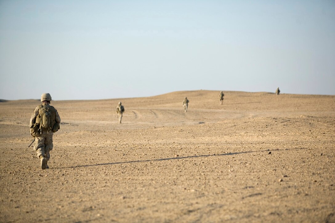 EXPEDITIONARY PATROL BASE - DULAB, Iraq, (Sept. 26, 2007) – Marines with 1st Platoon, Company A, 1st Battalion, 7th Marine Regiment, Regimental Combat Team 2, sweep through the desert on the outside of the city in a column. The company, known as the Animals, frequently goes on patrols lasting more than six hours, and regularly covers a dozen miles each day. (Official USMC photograph by Cpl. Shane S. Keller)