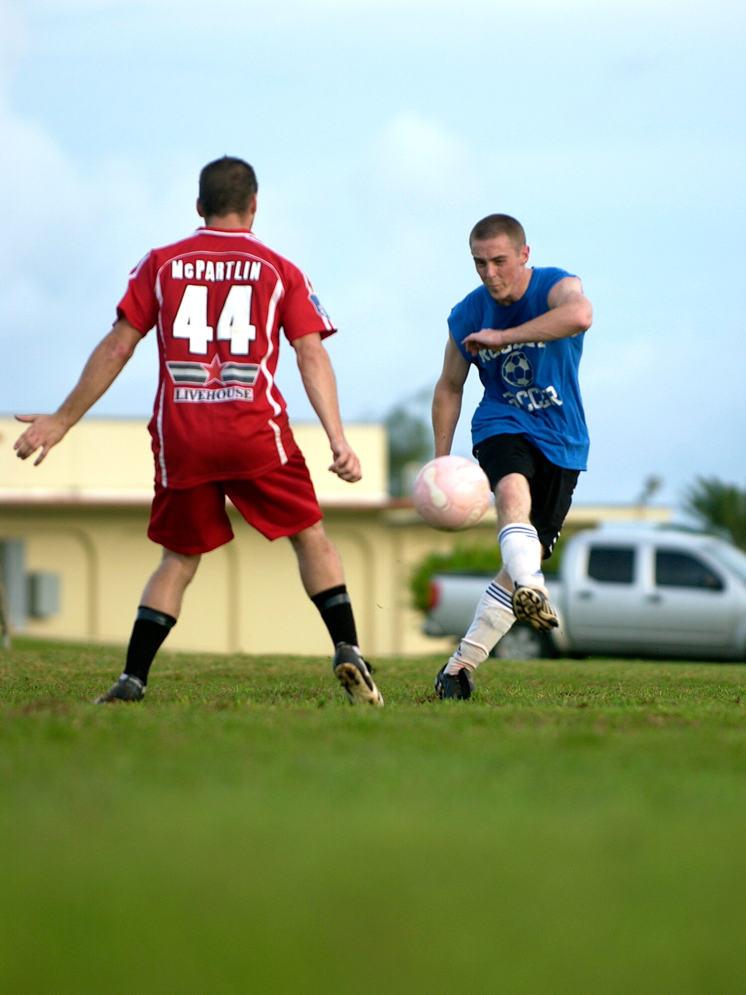 Senior Airman Brian Kimball, 36th Communications Squadron, kicks the ball past his opponent from the 36th Civil Engineering Squadron during their intramural soccer game, Sept. 25.  The 36th CES won the game against the 36th CS with a resulting score of 8-1.  (U.S. Air Force photo/Senior Airman Miranda Moorer)                                