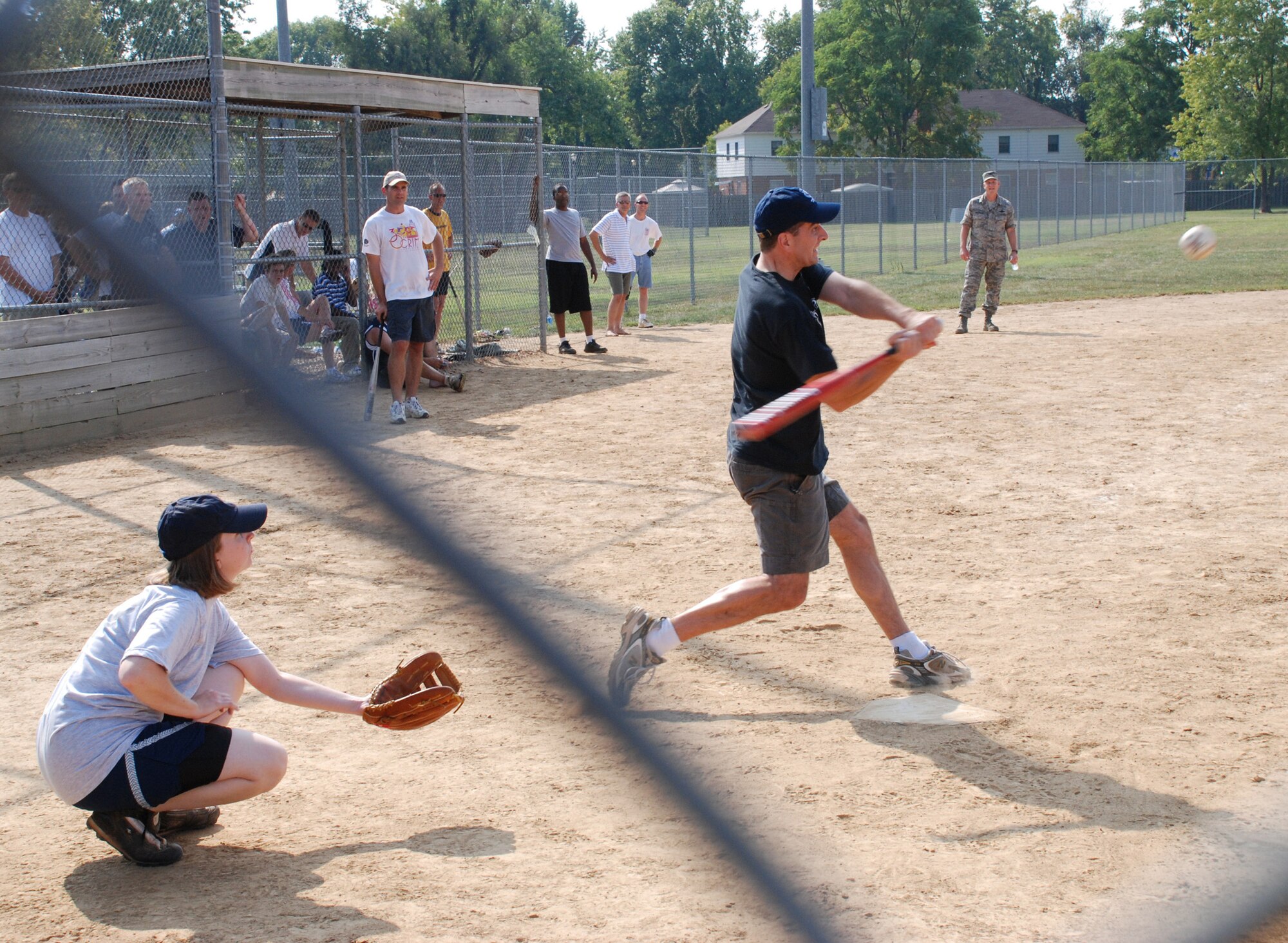 Hey there batter!  An officer of the 932nd Airlift Wing prepares to whack at the first pitch at the recent softball match.