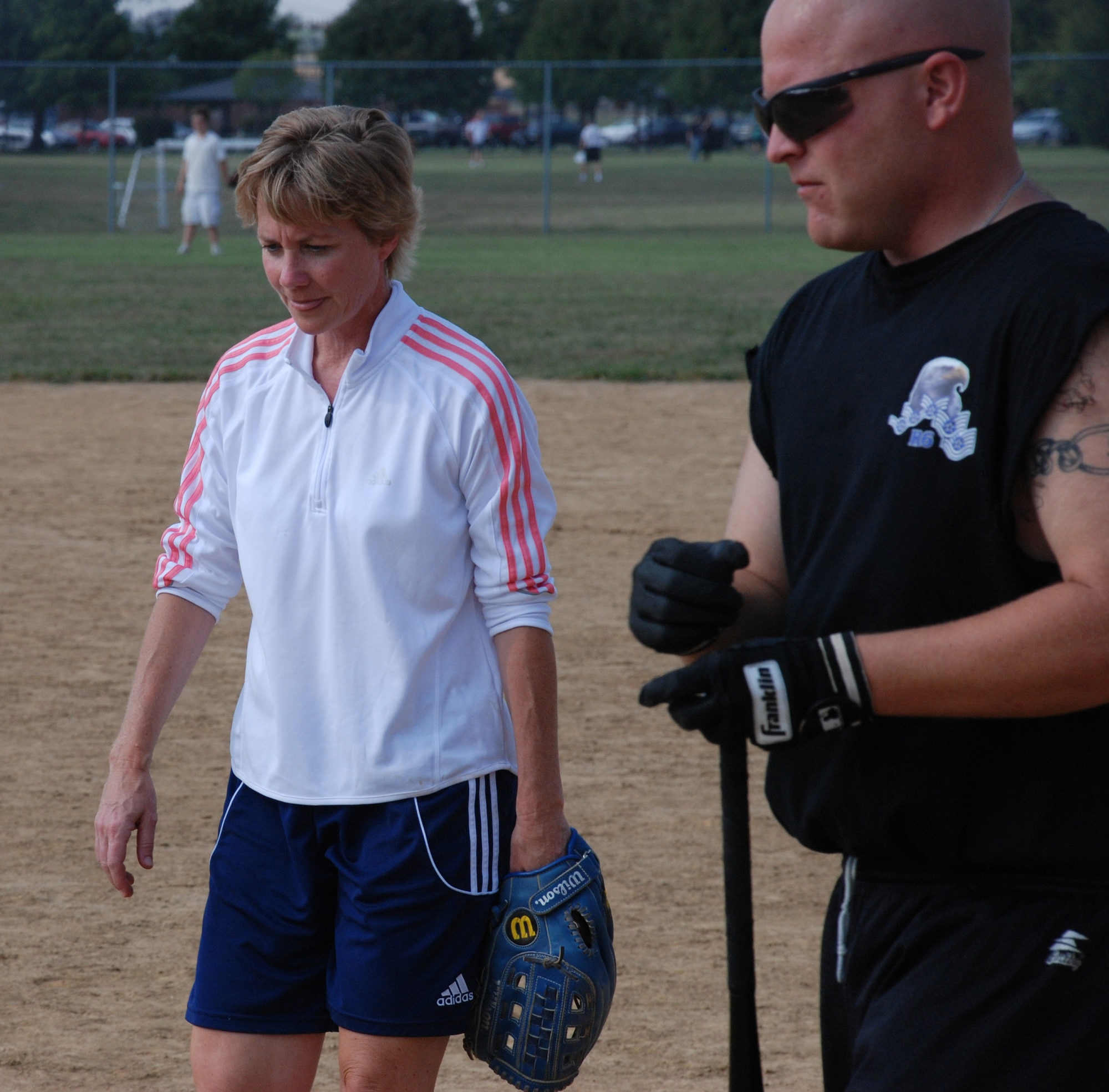 Hey there comander!  Col. Maryanne Miller, comanding officer of the 932nd Airlift Wing, talks to a softball ploayer as she prepares to play catcher at the recent softball match.  The hours long game ended in a 10-10 hard fought tie.  Photo/ Capt. Stan Paregien