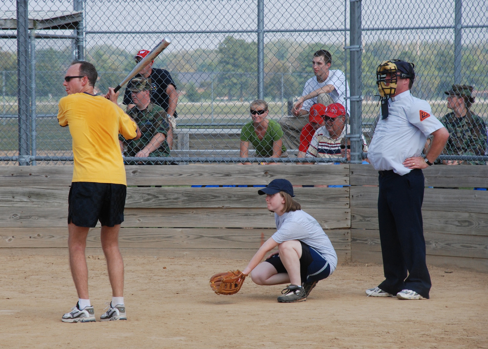 Hey there batter!  Chaplain Bell of the 932nd Airlift Wing prepares as a referee to see the first pitch at the recent softball match.