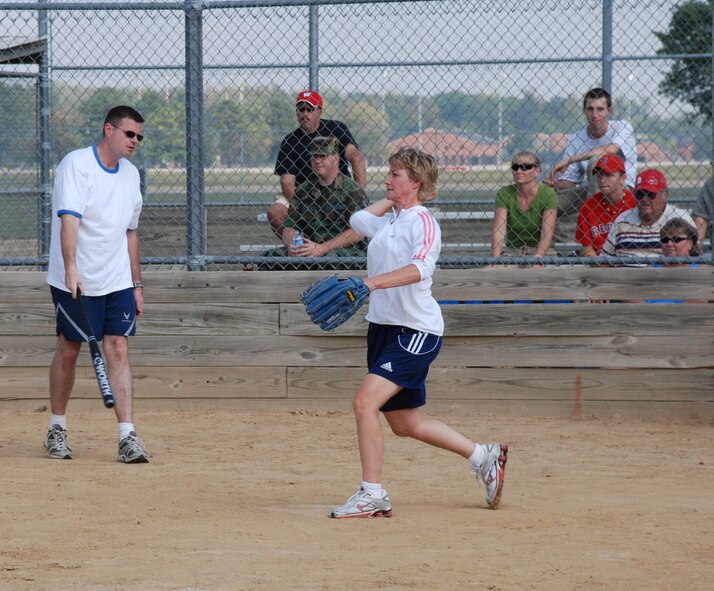 Get ready...Hey there batter!  An officer of the 932nd Airlift Wing prepares to throw out the first pitch at the recent softball match.