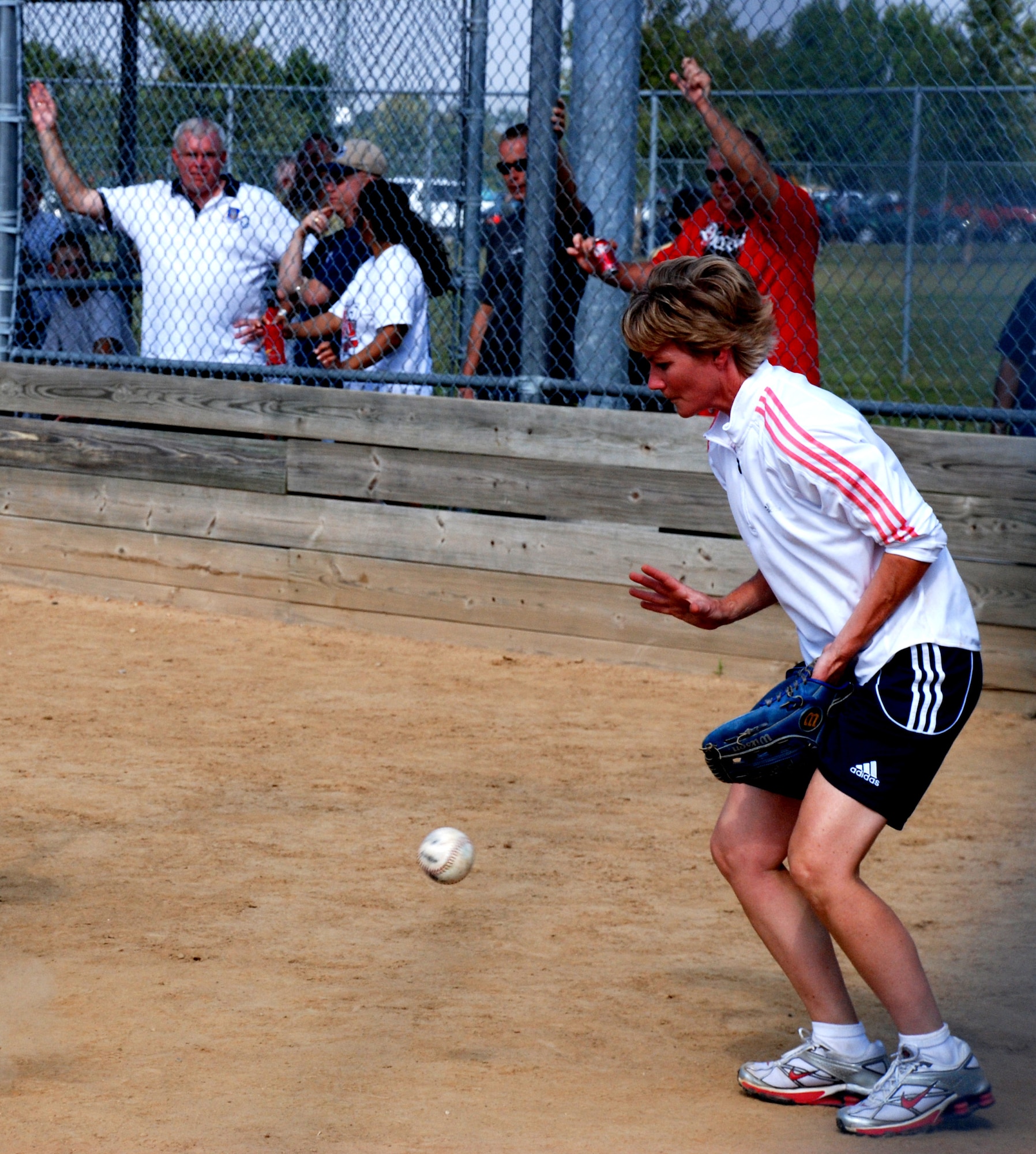 WOWZA!  Colonel Maryanne Miller keeps her eye on a wild pitch at the recent softball match.  Photo/ Capt. Stan Paregien