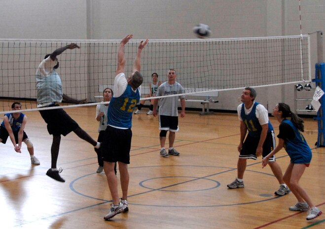 The 437th Civil Engineer Squadron defeats the 437th Communications Squadron in two close games of volleyball scoring 25-17 and 25-23 Tuesday night at the Fitness and Sports Ceneter. (U.S. Air Force photo/Airman 1st Class Cynthia Spalding)