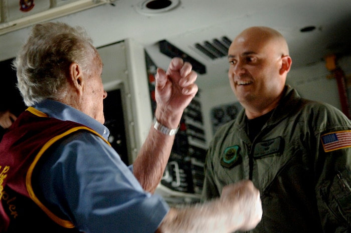 Tech. Sgt. Sidney DeLeon, 437th Operations Support Squadron, talks with a former prisoner of war during an observance of loading fallen casualties in a Charleston C-17 Sept. 21 on Charleston AFB, S.C.(U.S. Air Force photo/Airman 1st Class Nicholas Pilch)