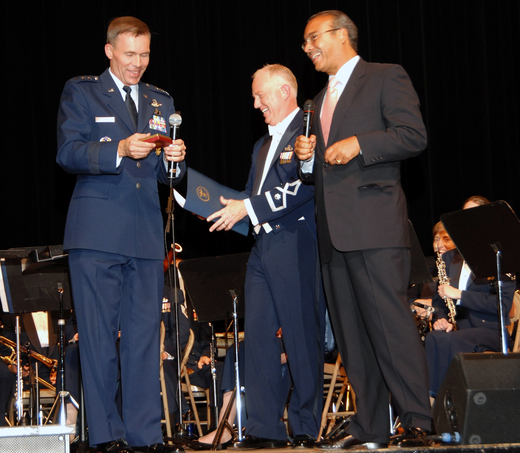 Lt. Gen. John L. Hudson (left), commander of Aeronautical Systems Command, presents Columbus, Ohio, Mayor Michael B. Coleman with an Air Force memento during a band concert Sept. 26 in appreciation for the mayor's support to Air Force Heritage Week.  Lt. Col. Alan Sierichs, commander of the U.S. Air Force Band of Flight, holds the proclamation the mayor read establishing Air Force Heritage Week in Columbus.  (U.S. Air Force photo/Al Bright)