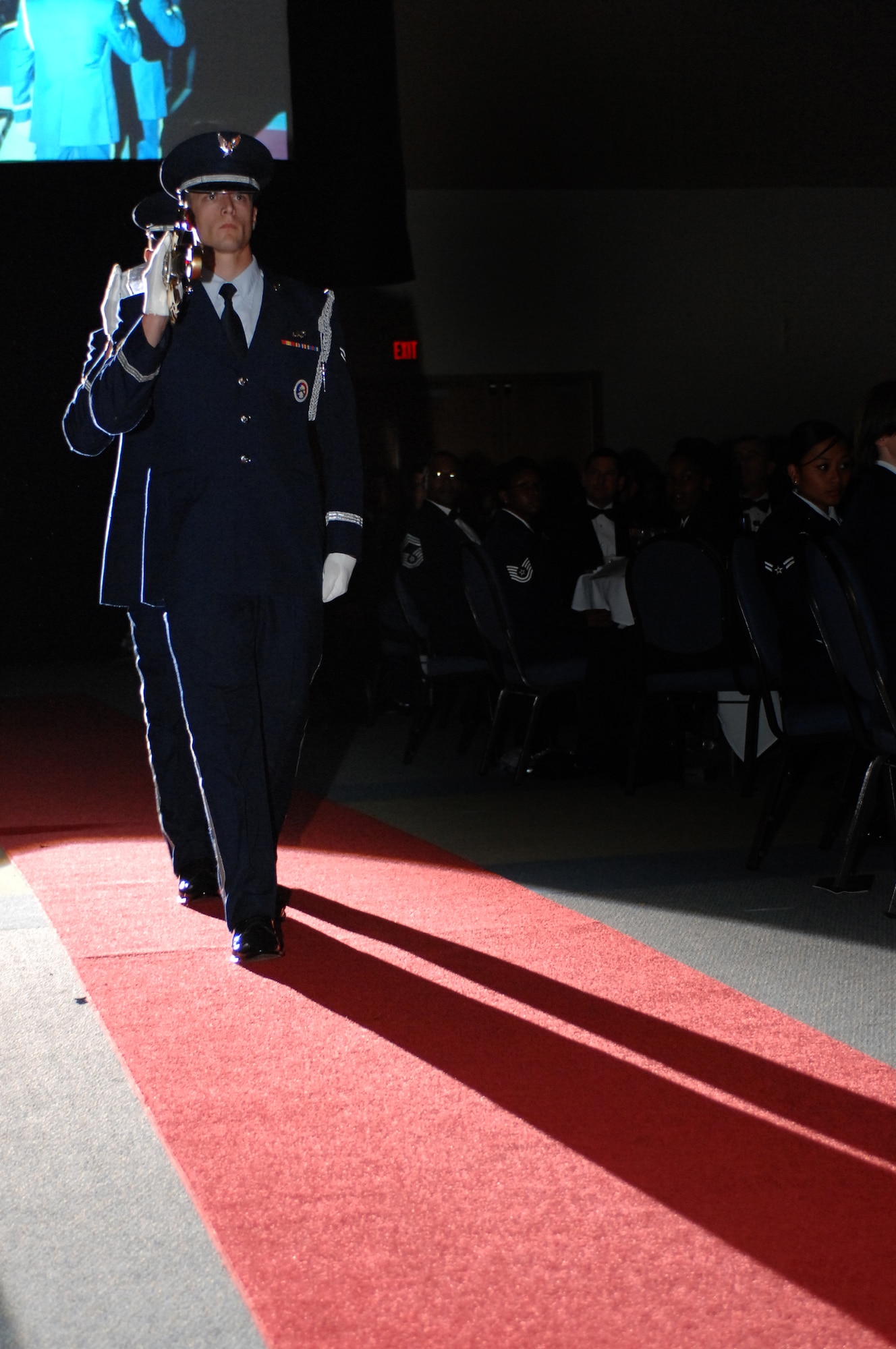 Airmen 1st Class Matt Todd and Jake Krekelberg, from the Hurlburt Field Honor Guard walk the ceremonial sword down the red carpet during the Order of the Sword ceremony for Lt. Gen. Mike Wooley, Air Force Special Operation Command, commander, at the Emerald Coast Conference Center, Okaloosa Island, Fla., Sept. 21, 2007. The traditional posting of the ceremonial sword represents the beginning of the event. (U.S. Air Force photo by SrA Julianne M. Showalter)(RELEASED)
