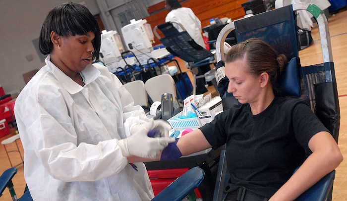 Airman 1st Class Jessica Orozco, 437th Maintenance Squadron AGE mechanic, gets her arm wrapped by Faye Holmes, American Red Cross phlebotomist, after she gave blood. Members of Team Charleston donated 82 pints of blood during the blood drive Wednesday in the Fitness & Sports Center. (U.S. Air Force photo/Airman Melissa White)