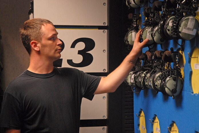 Airman 1st Class Scott Rowland, 437th Aircraft Maintenance Squadron flightline support specialist, grabs a headset from the wall for a customer in the consolidated tool kit room on Charleston AFB Wednesday. (U.S. Air Force photo/Airman Melissa White)