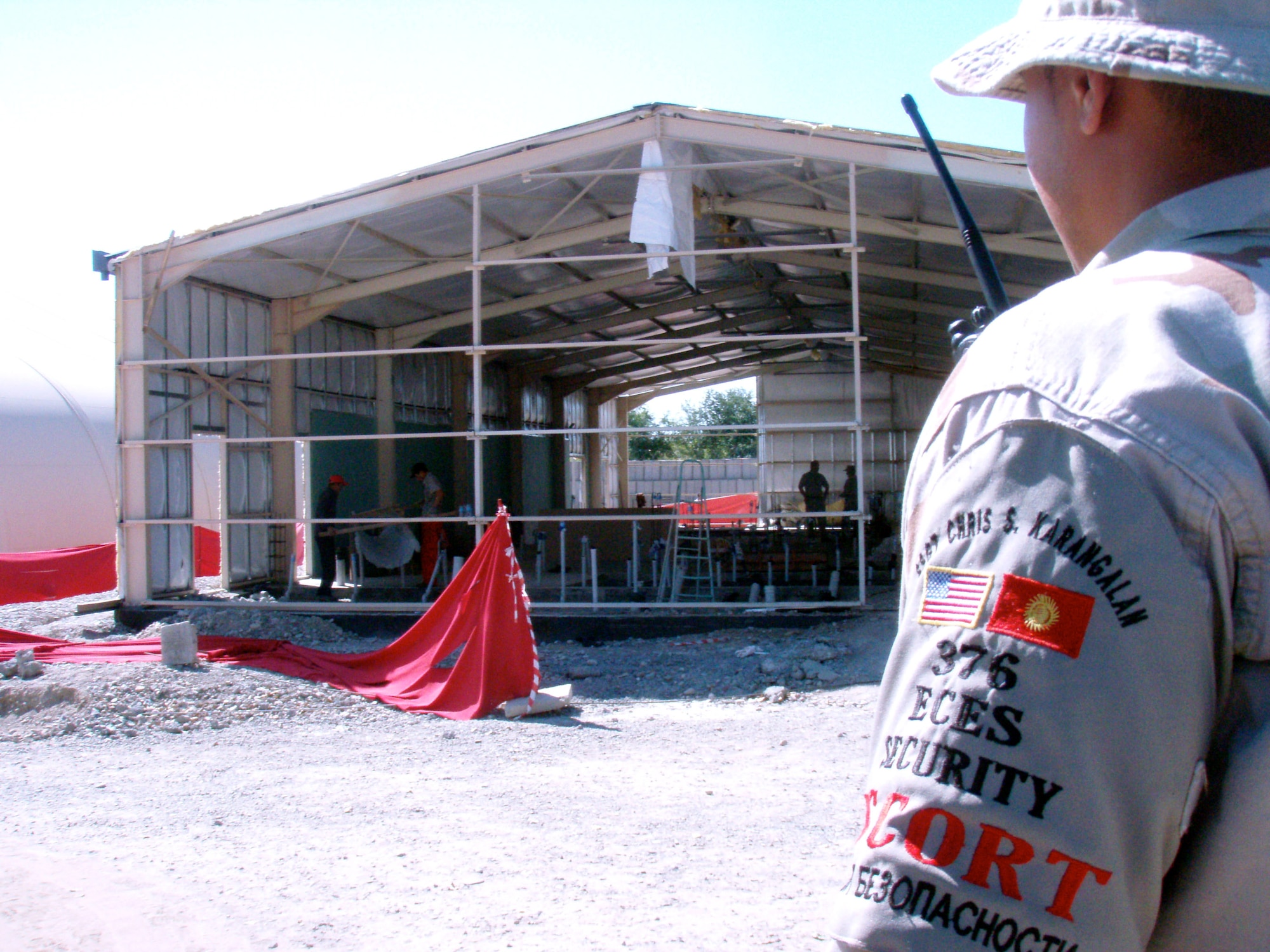 Staff Sgt. Chris Karangalan watches over workers at a construction site Aug. 29 on Manas Air Base, Kyrgyzstan.  Sergeant Karangalan is with the 376th Expeditionary Civil Engineering Squadron's Security Escort Flight. Sergeant Karangalan is deployed from Edwards Air Force Base, Calif.  (U.S. Air Force photo/Senior Airman Kyle Knox)
