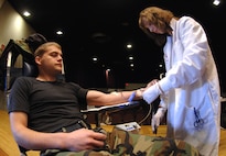 MINOT AIR FORCE BASE, N.D. --Tammy Volk, United Blood Services worker, assists Airman 1st Class William Hirner, 91st Missile Maintenance Squadron, in donating blood to the UBS at the base theater September 26. The event was organized by the base Airmen Against Drunk Driving committee. Approximately 50 people came to donate blood.(U.S. Air Force photo by Senior Airman Christopher Boitz)
