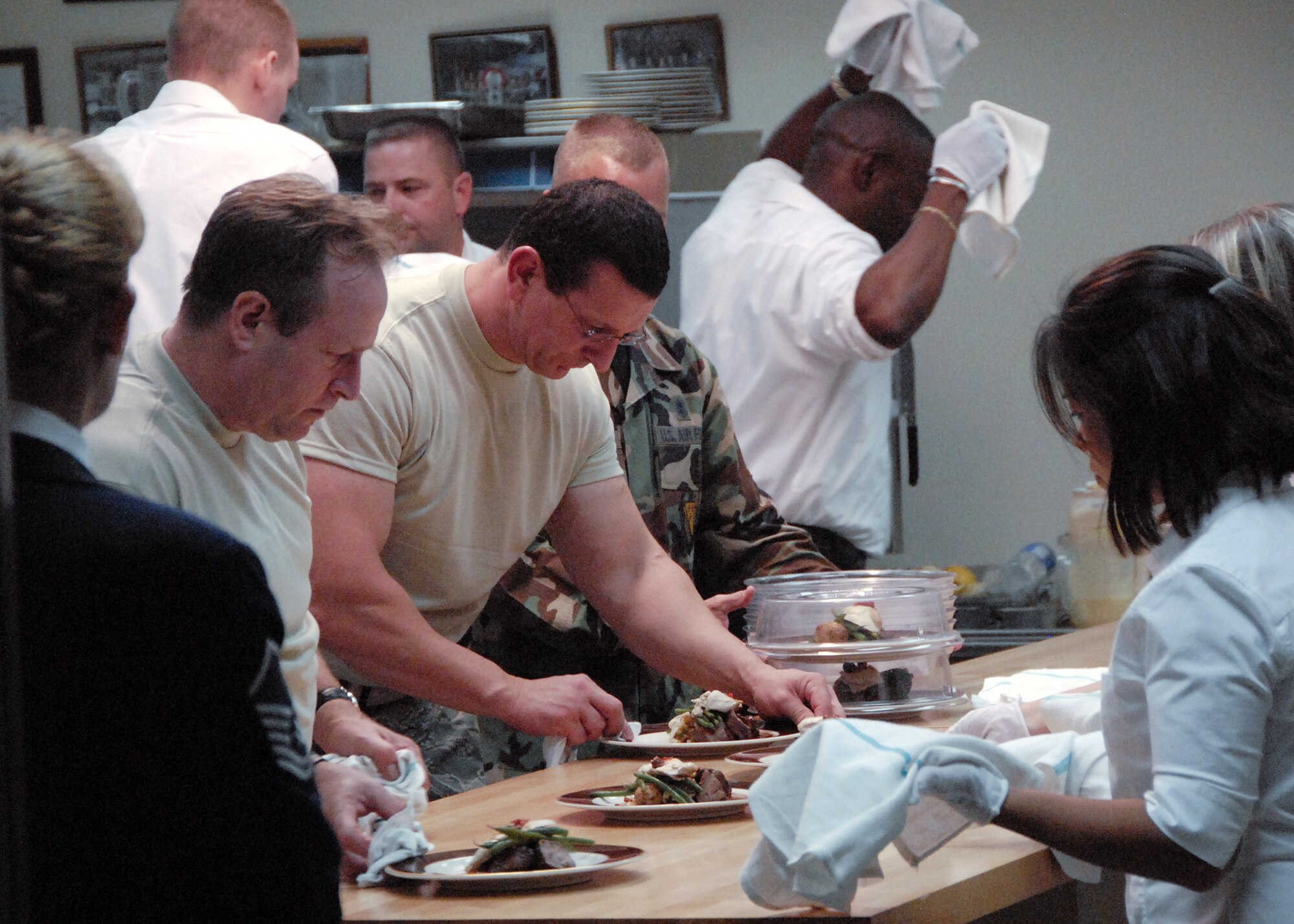 Chef Robert Irvine (center) of the Food Network's hit show 'Dinner: Impossible' plates a meal the evening of Sept. 22 during Sheppard's celebration of the Air Force's 60th Anniversary. The chef had less than 10 hours to gather and prepare food for 1,000 Airmen and guests at the celebration. (U.S. Air Force photo/Harry Tonemah)