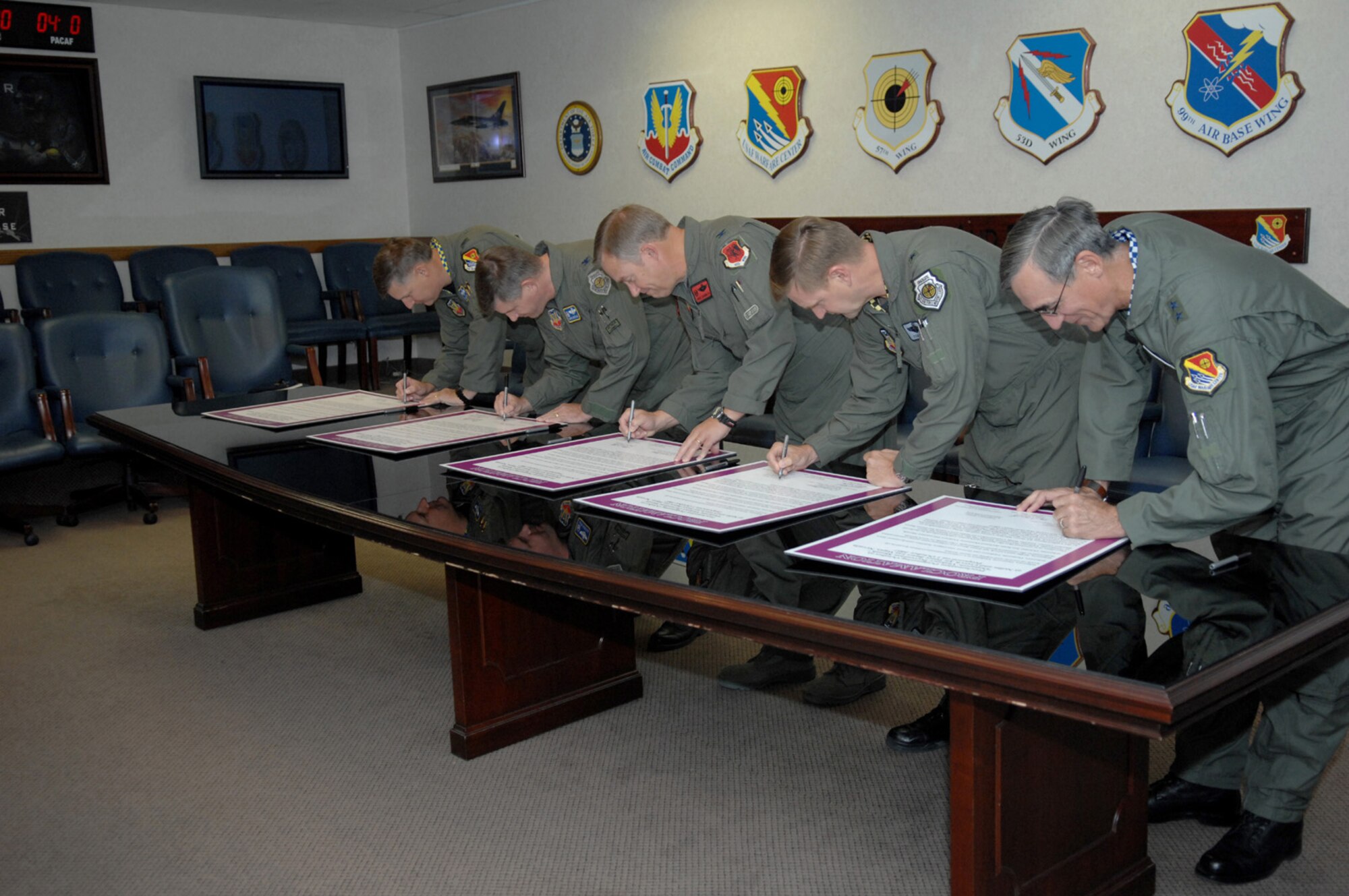 From right to left, Maj. Gen. R. Michael Warden, U.S. Air Force Warfare Center commander,  Brig. Gen. Stephen L. Hoog, 57th Wing commander, Col. Christopher Chambliss, 432nd Wing commander,  Col. Mark E. Koechle, 98th Range Wing commander, and Col. Michael L. Bartley, 99th Air Base Wing commander, sign a proclamation declaring October as Domestic Violence Prevention Month for Nellis Air Force Base and Creech Air Force Base at the U.S. Air Force Warfare Center conference room on Sept. 25, 2007.  Family Advocacy will use October to educate people on Nellis Air Force base how to help combat domestic violence. (U.S. Air Force Photo by SSgt Erin T. Worley)    