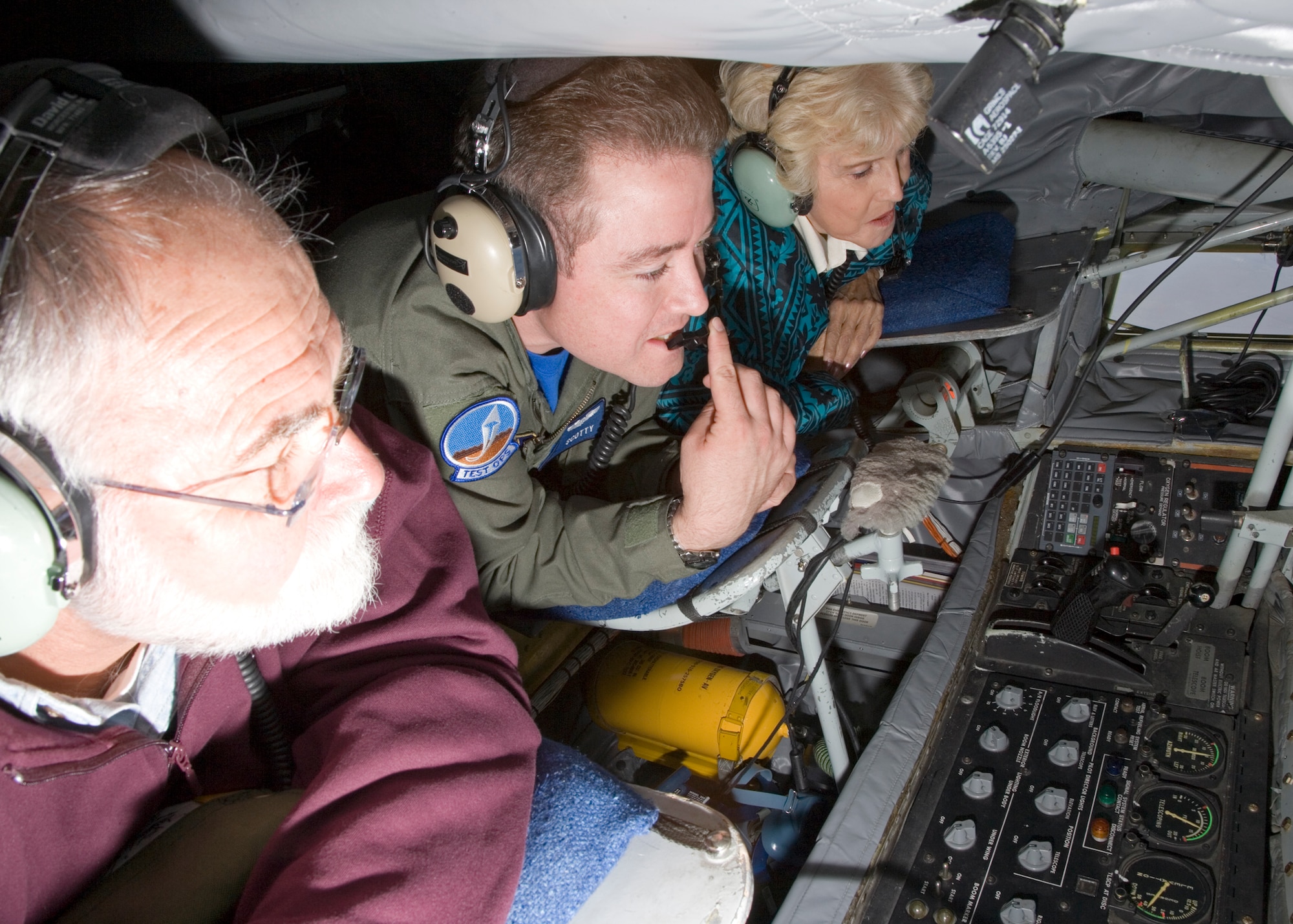 Tech. Sgt. Scott Scurlock (center), 370th Flight Test Squadron boom operator, demonstrates aerial refueling techniques to Aida O'Connor (right) and John Uhazy, Edwards Civilian-Military Support Group members, during an incentive ride on a KC-135 Stratotanker here Sept. 21. (Photo by Bobbi Zapka)