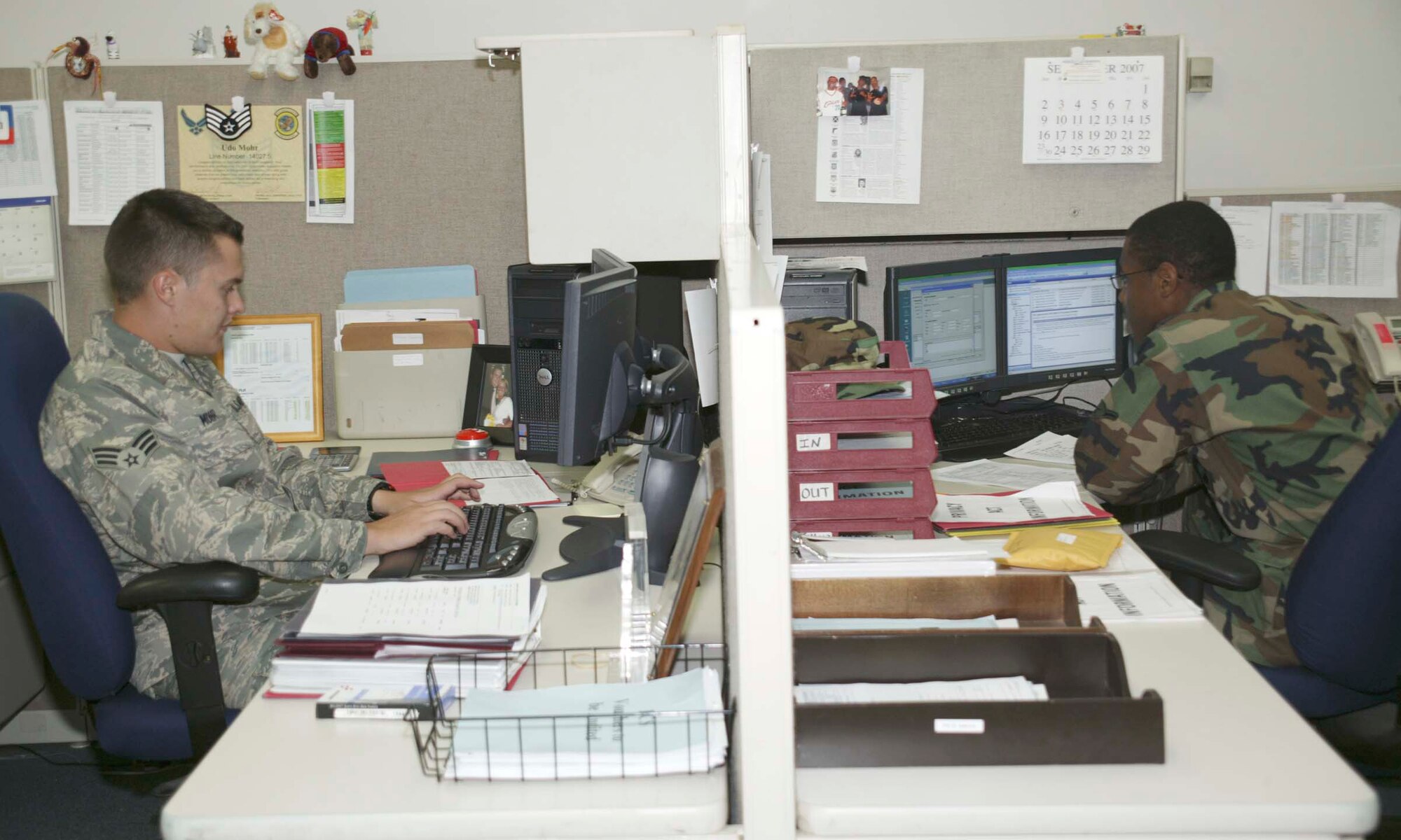 SHAW AIR FORCE BASE, S.C. -- (From left) Senior Airman Udo Mohr and Airman Jawann Hazzard, 20th Comptroller Squadron financial customer service technicians, work in the customer service office Sept. 24. As of Nov. 30, Shaw financial customer service actions will take place at the new Air Force Financial Services Center at Ellsworth AFB, S.D., via MyPay online. (U.S. Air Force photo/Senior Airman Holly Brown)