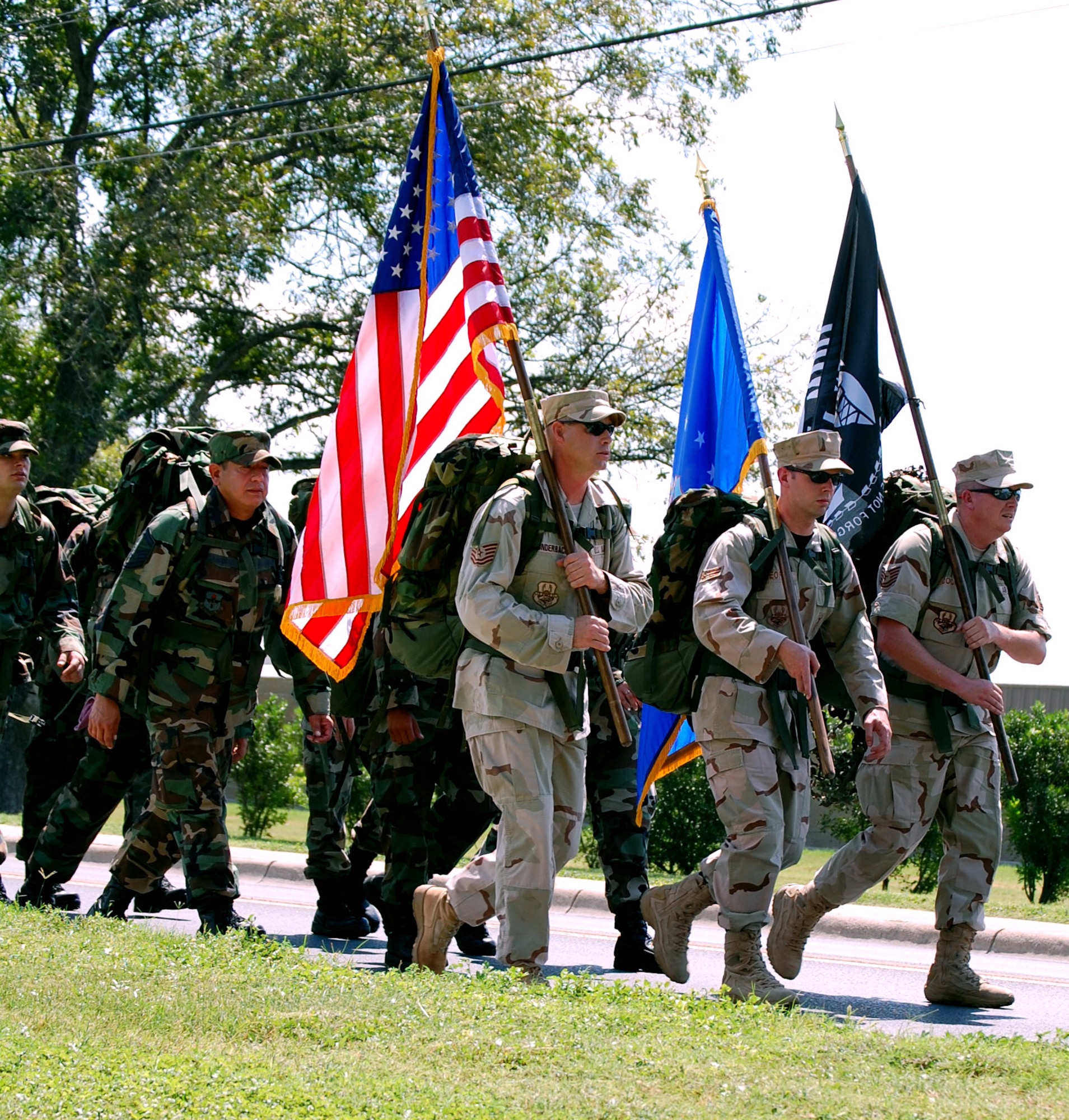 LAUGHLIN AIR FORCE BASE, Texas – Tech Sgt. Thomas Cooper, Senior Airman Forrest George, and Tech Sgt. Frank Munderback, 47th Security Forces Squadron, lead a group of more than nearly 50 from Laughlin on a 7 mile walk from base to the Dr. Alfredo Gutierrez Jr. Amphitheatre, Del Rio, Texas, Sept. 21 for the National POW/MIA Recognition ceremony. (U.S. Air Force photo by Airman Sara Csurilla)
