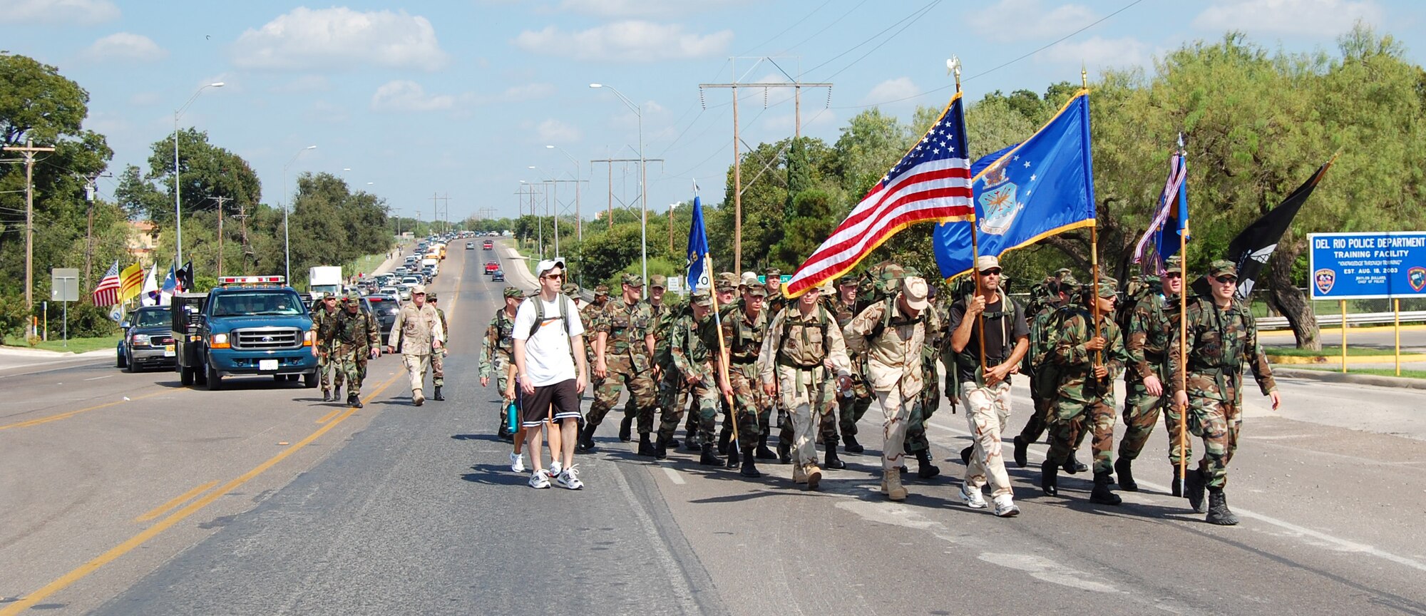 LAUGHLIN AIR FORCE BASE, Texas – Laughlin members, a group of veterans  that walked 340 miles from Alvin, Texas, local fallen heroes families and many others cross Highway 90 in Del Rio, Texas, Sept 21, during the a 7 mile walk for of National POW/MIA Recognition Day. (U.S. Air Force photo by Airman Sara Csurilla)