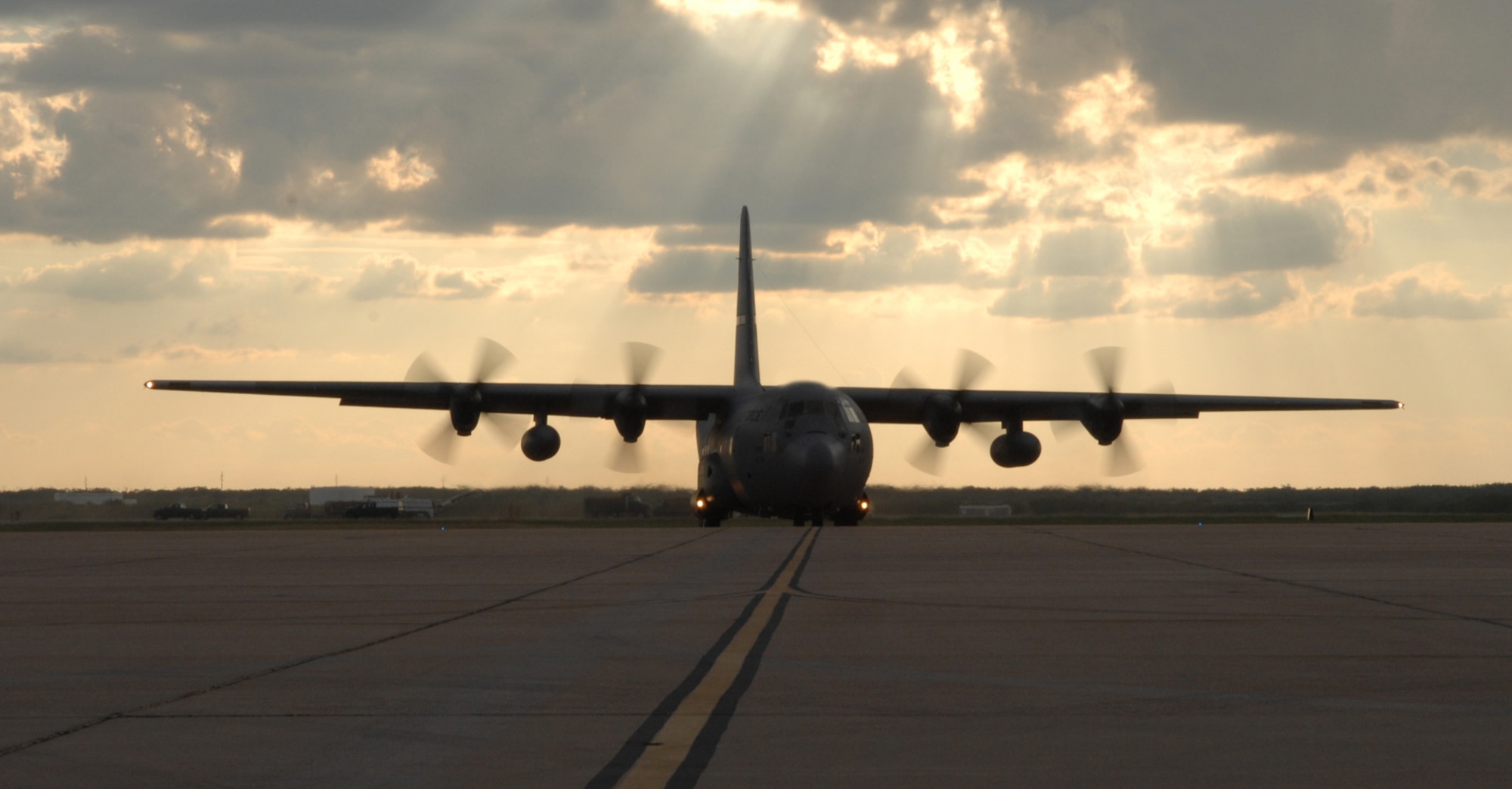 DYESS AIR FORCE BASE, Texas - A C-130 takes off from Dyess' taxiway Sept. 24. After the main runway on base was closed for about 60 days for repair and 20 B-1s were relocated, the taxiway here was repainted and lighting was moved to make it usable to the 317th Airlift Group's Hercs stationed here. This transition to using a taxiway for daily operations is a historic move for the Air Mobility Command aircraft, but the "trash haulers" of the sky are designed to be able to land on small areas, even dirt strips when necessary, making the change an easy one for Dyess. (U.S. Air Force photo by Airman 1st  Class Jennifer Romig)
