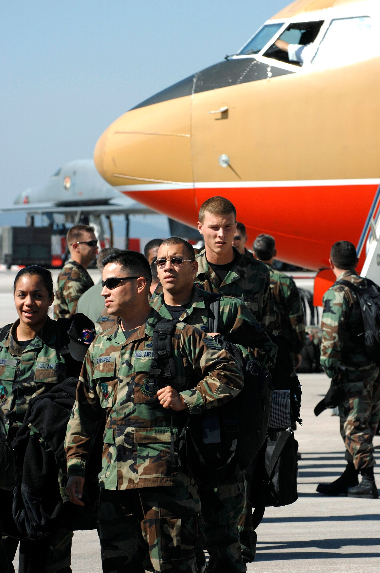 Airmen from the 7th Bomb Wing at Dyess Air Force Base, Texas, exit an aircraft on the flightline Sept. 20 at Ellsworth AFB, S.D. Ellsworth AFB will temporarily house 550 Airmen and 20 B-1 aircraft from Dyess AFB while 6,600 feet of runway are under repair there. (U.S. Air Force photo/Staff Sgt. Michael Keller) 