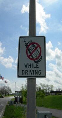 A posted sign near Spirit Gate reminds vehicle operators they cannot talk on cell phones while driving on base. (Photo printed with permission of Tech. Sgt. Raul Betancourt)