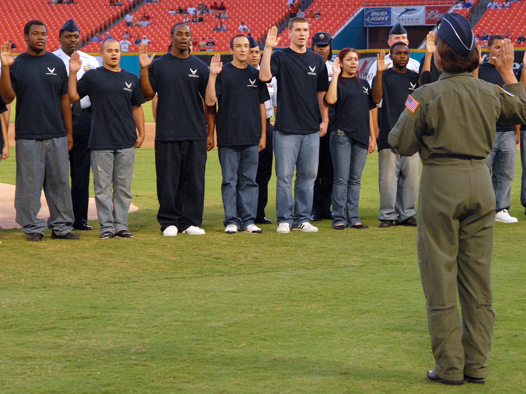 Brigadier General, Suzanne M. Vautrinot , commander of Air Force Recruiting Service, conducts a large-group enlistment swear-in before a Florida Marlins baseball game versus the New York Mets in Miami, Sept. 21.  The 333rd RCS worked with the Marlins marketing team to organize the event for the many new enlistees to happen before the beginning of the game.  (Photo/Army Sgt. Mitch Miller)