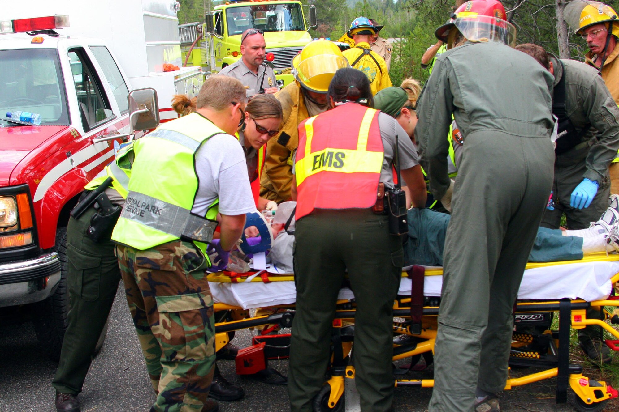 WRIGHT-PATTERSON AFB, Ohio - Master Sgt. James Foy (front left), 445th Aeromedical Staging Squadron, works with national park EMTs to assist a victim of a car accident. The 445th ASTS partners with our country's national parks to provide support for the EMT services. (Courtesy photo)