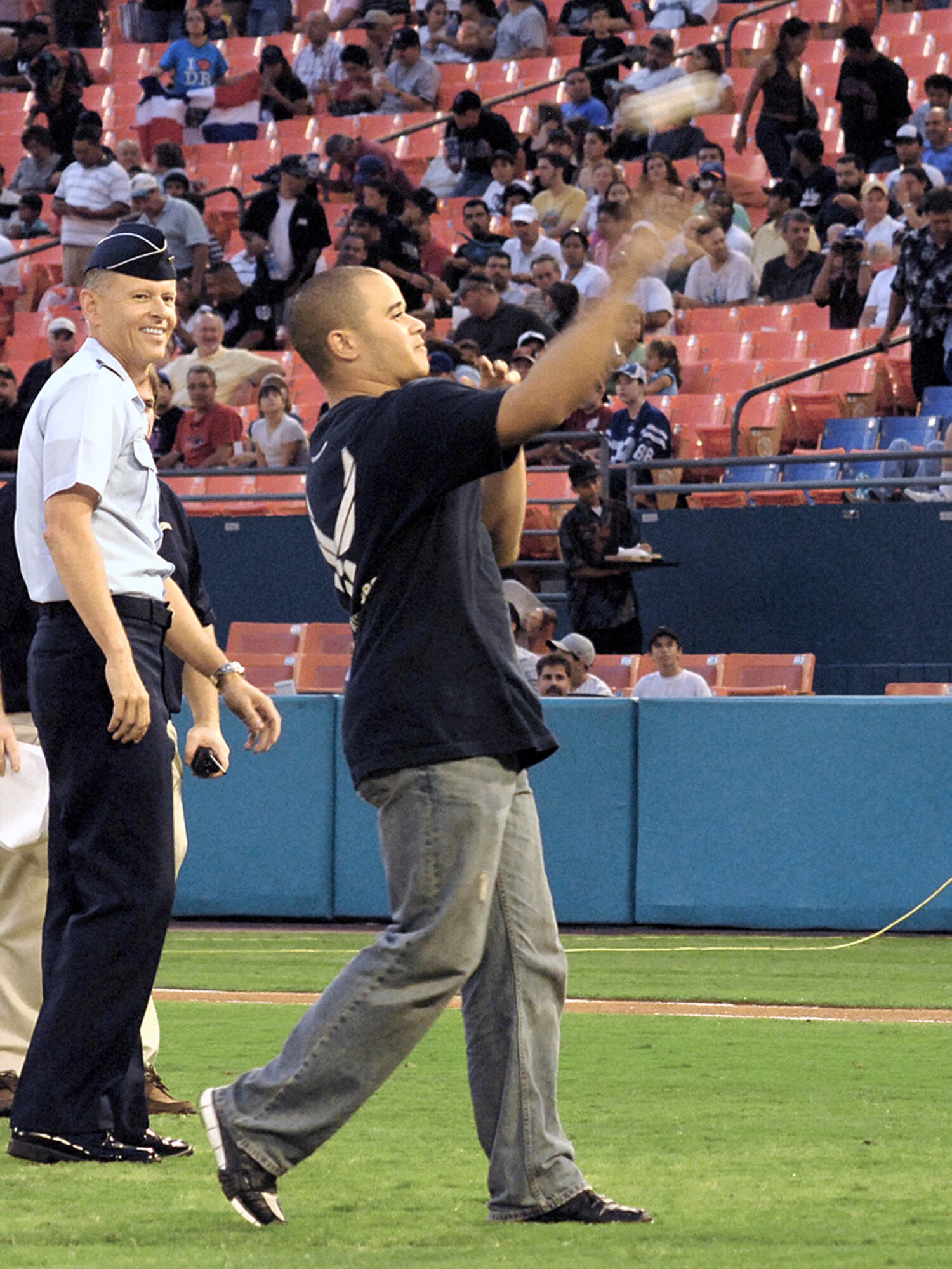 New Air Force enlistee, Adrian Garcia, throws out the first pitch at a Florida Marlins game that was preceded by a delayed enlistment program swear-in, Sept 21 in Miami.  Adrian, who is of Dominican decent, is now waiting to go to basic military training and later become a Survival, Evasion, Resistance and Escape (SERE) specialist. Staff Sergeant Ricardo Miguez-Pazo recruited him in Miami. (Photo/Army Sgt. Mitch Miller)