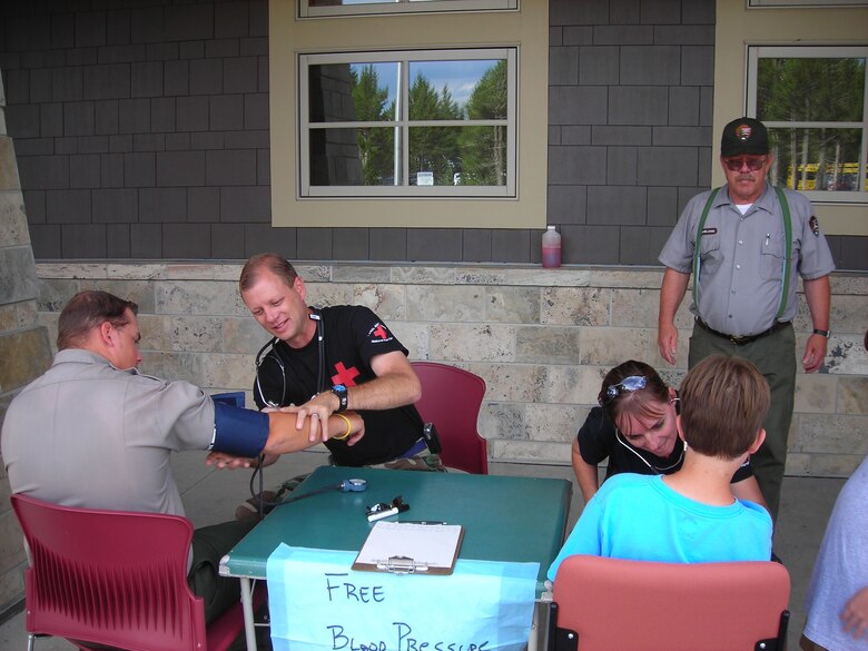 WRIGHT-PATTERSON AFB, Ohio - Tech. Sgt. Jerry Coleman and Capt. Nancie Foster, both from the 445th Aeromedical Staging Squadron, offer free blood pressure checks for visitors to Yellowstone National Park. The 445th ASTS partners with our country's national parks to provide support for the park's EMT services. (Courtesy photo)